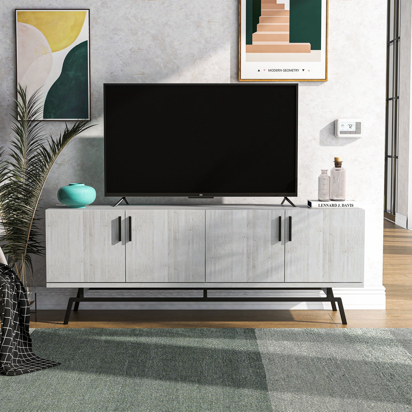 Front-facing modern white oak and black four-door TV stand in a living room with accessories