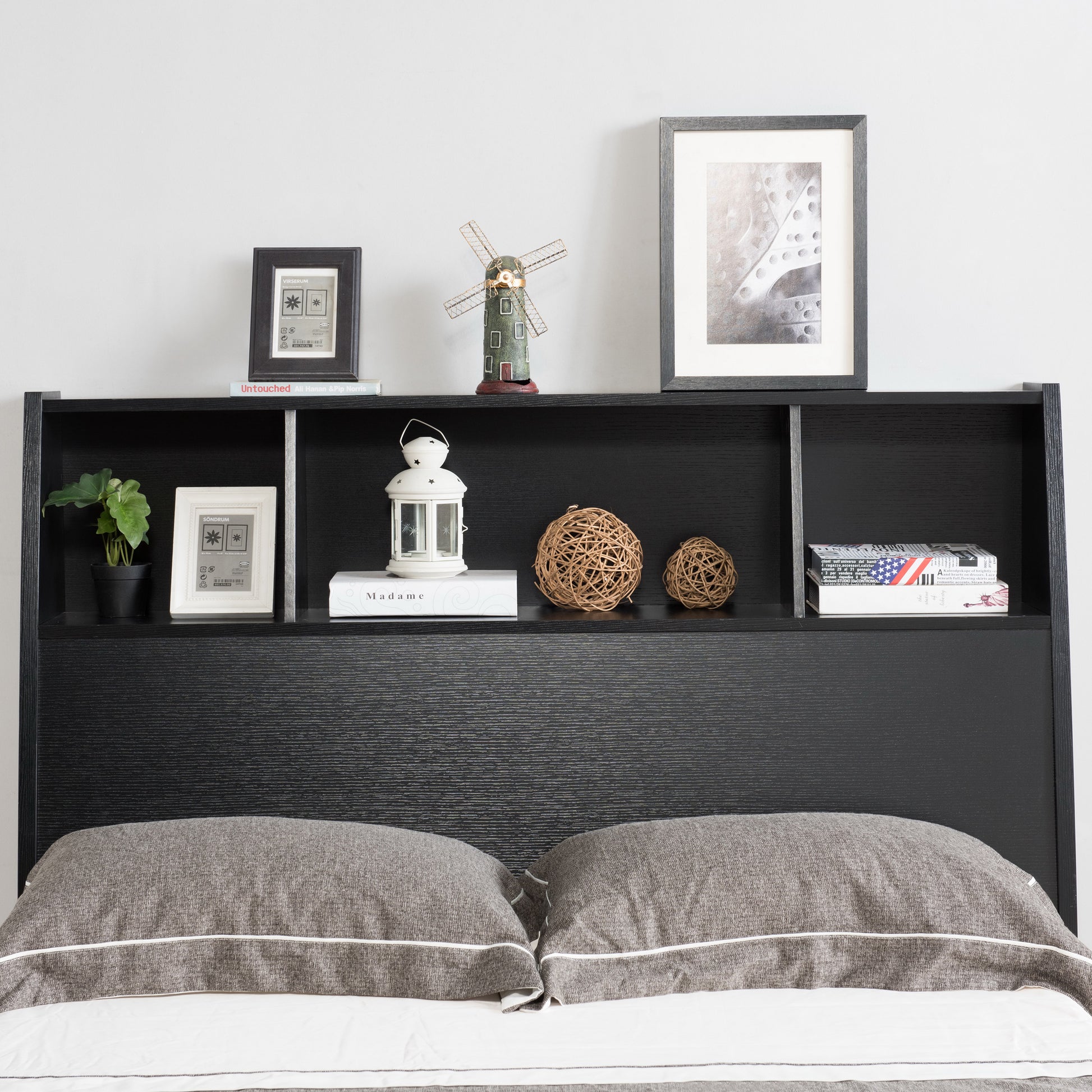 Front-facing contemporary cappuccino three-shelf bookcase storage headboard in a bedroom with accessories