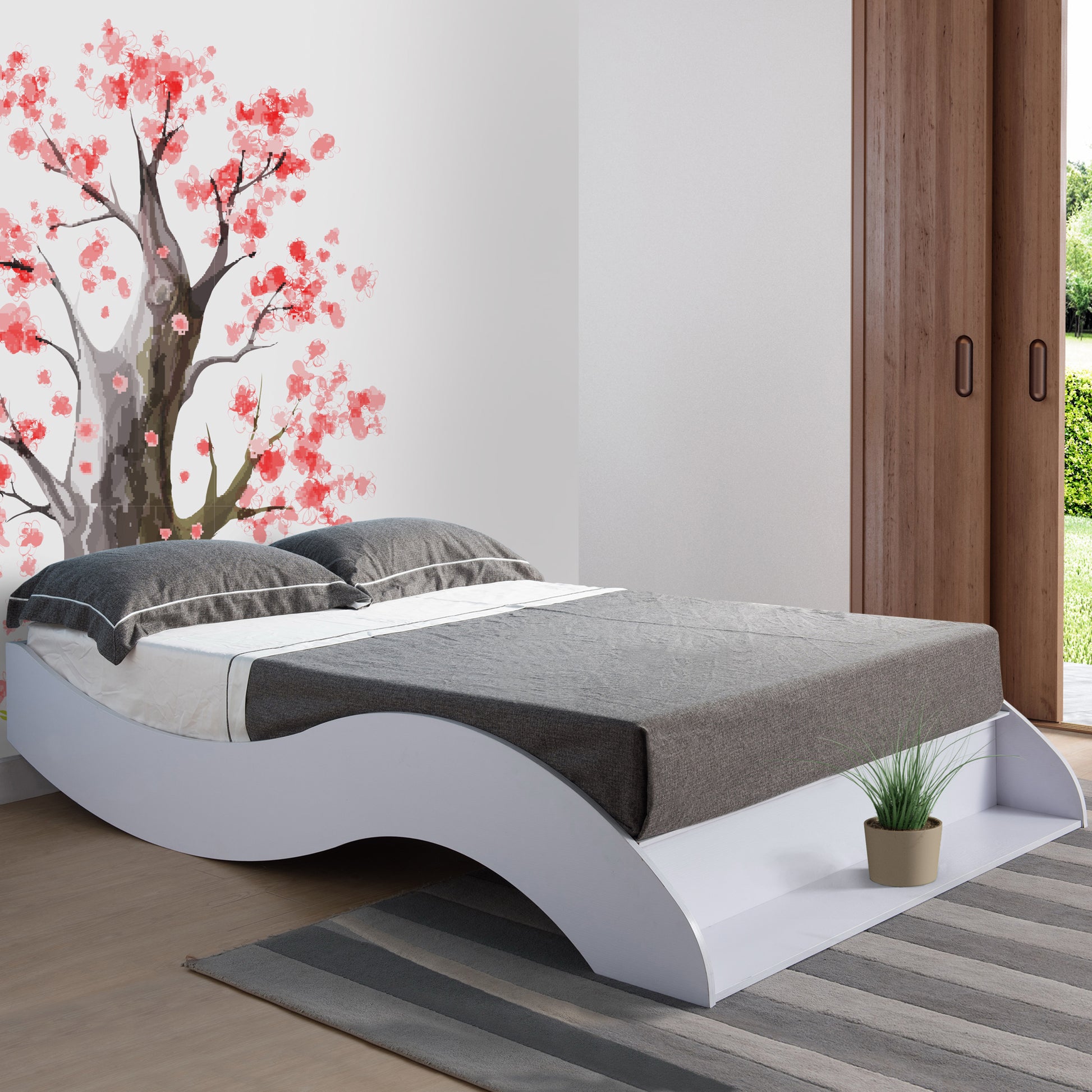 Right angled contemporary white curvy queen platform bed in a bedroom with accessories
