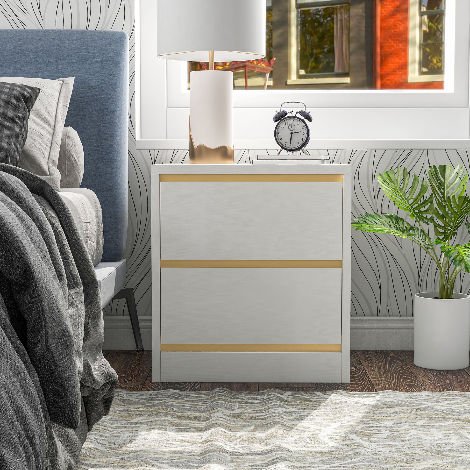 Front-facing modern white and gold two-drawer nightstand in a bedroom with accessories