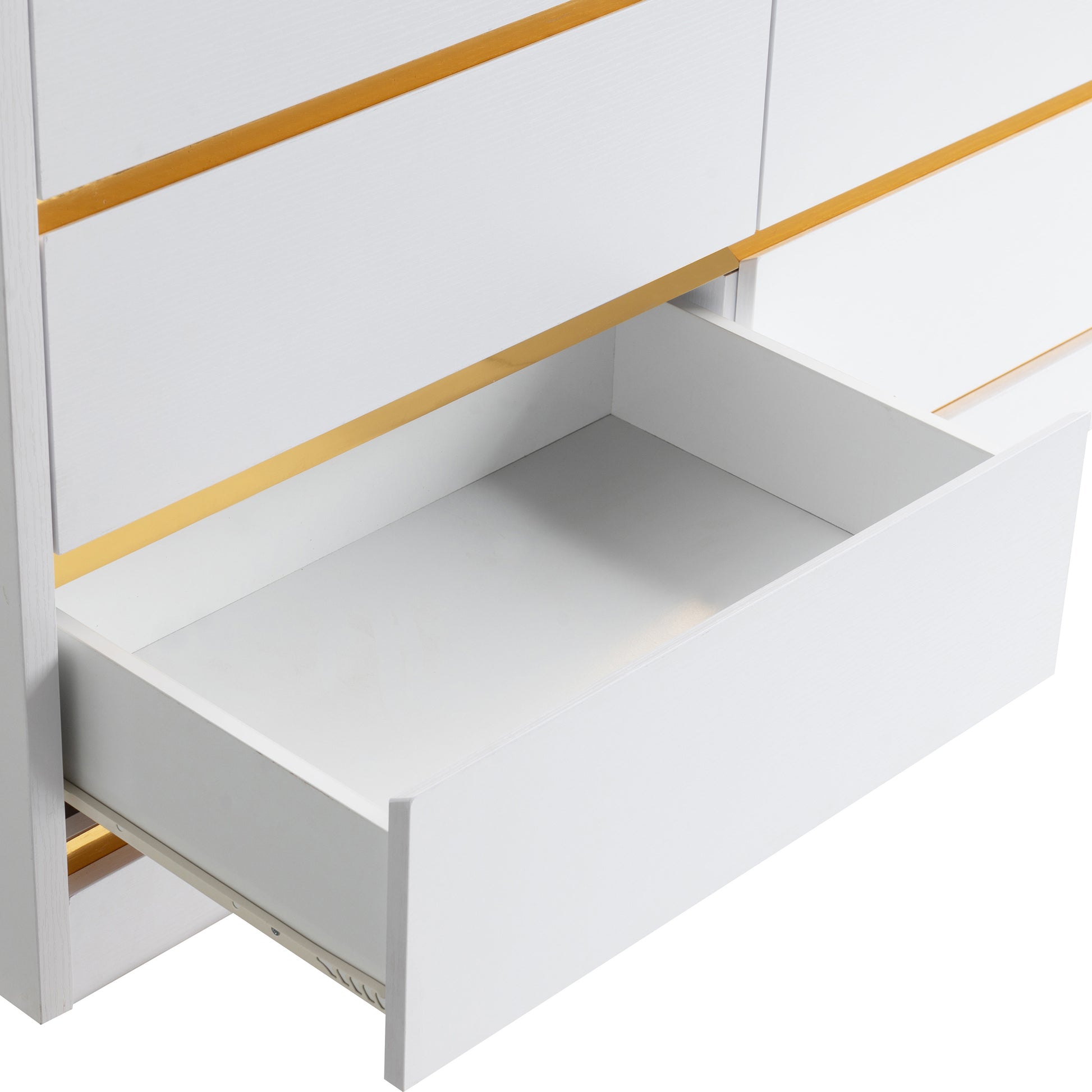 Right angled close-up of a modern white and gold six-drawer double dresser with bottom drawer open on a white background