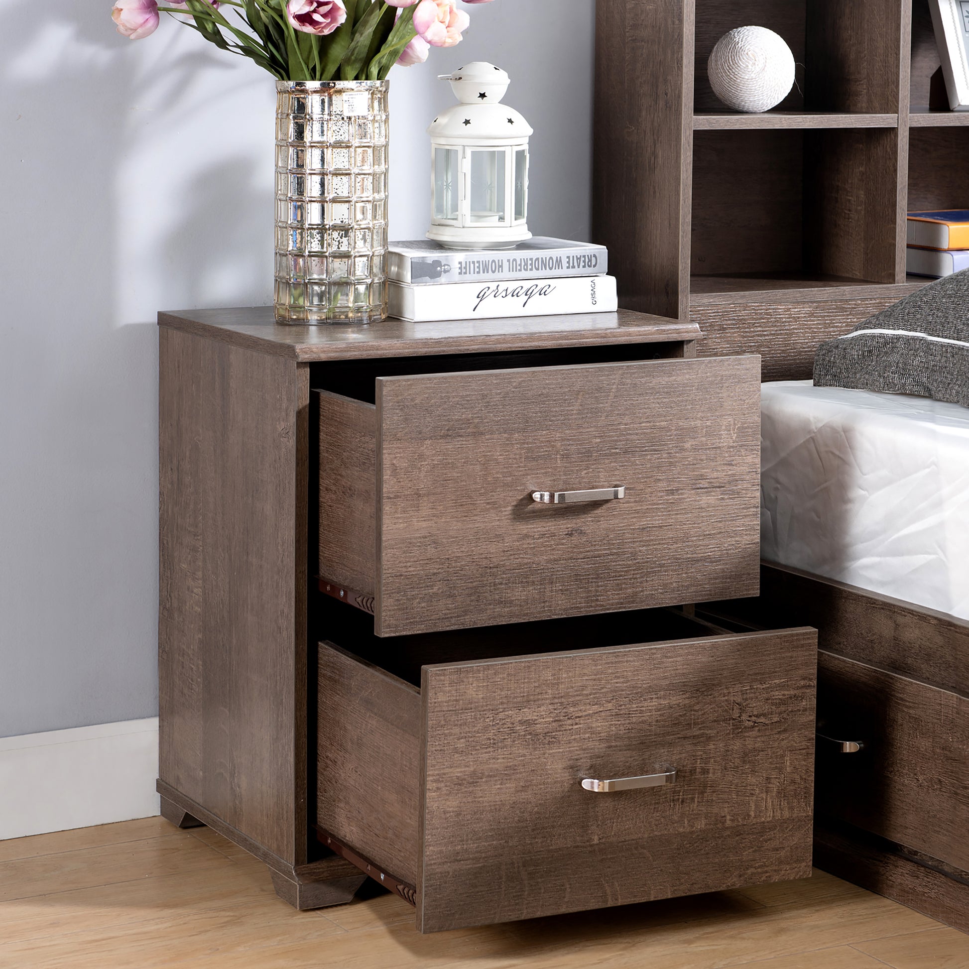 Right angled close-up of a two-piece contemporary walnut multi-storage bedroom set with nightstand drawer open in a bedroom with accessories