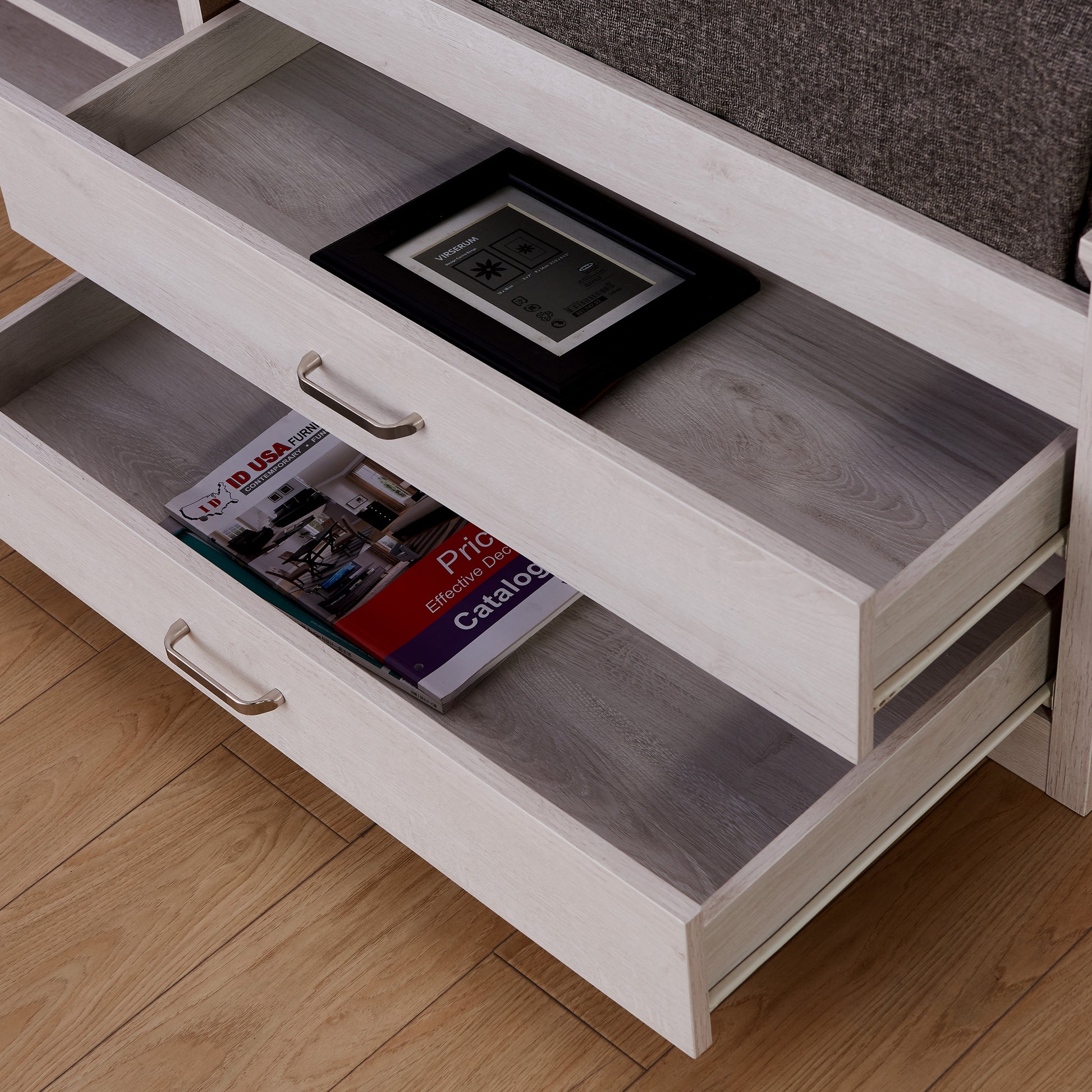 Right angled close-up of a transitional white two-drawer four-shelf storage bed with drawers open in a bedroom with accessories