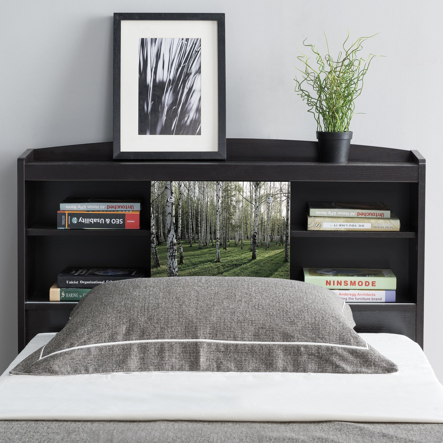 Front-facing contemporary cappuccino six-shelf bookcase headboard with sliding center panel in a bedroom with accessories