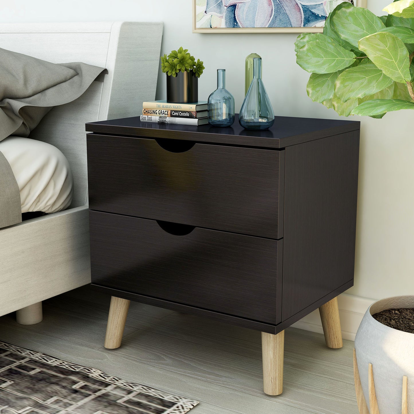 Left angled mid-century modern cappuccino two-drawer nightstand in a bedroom with accessories