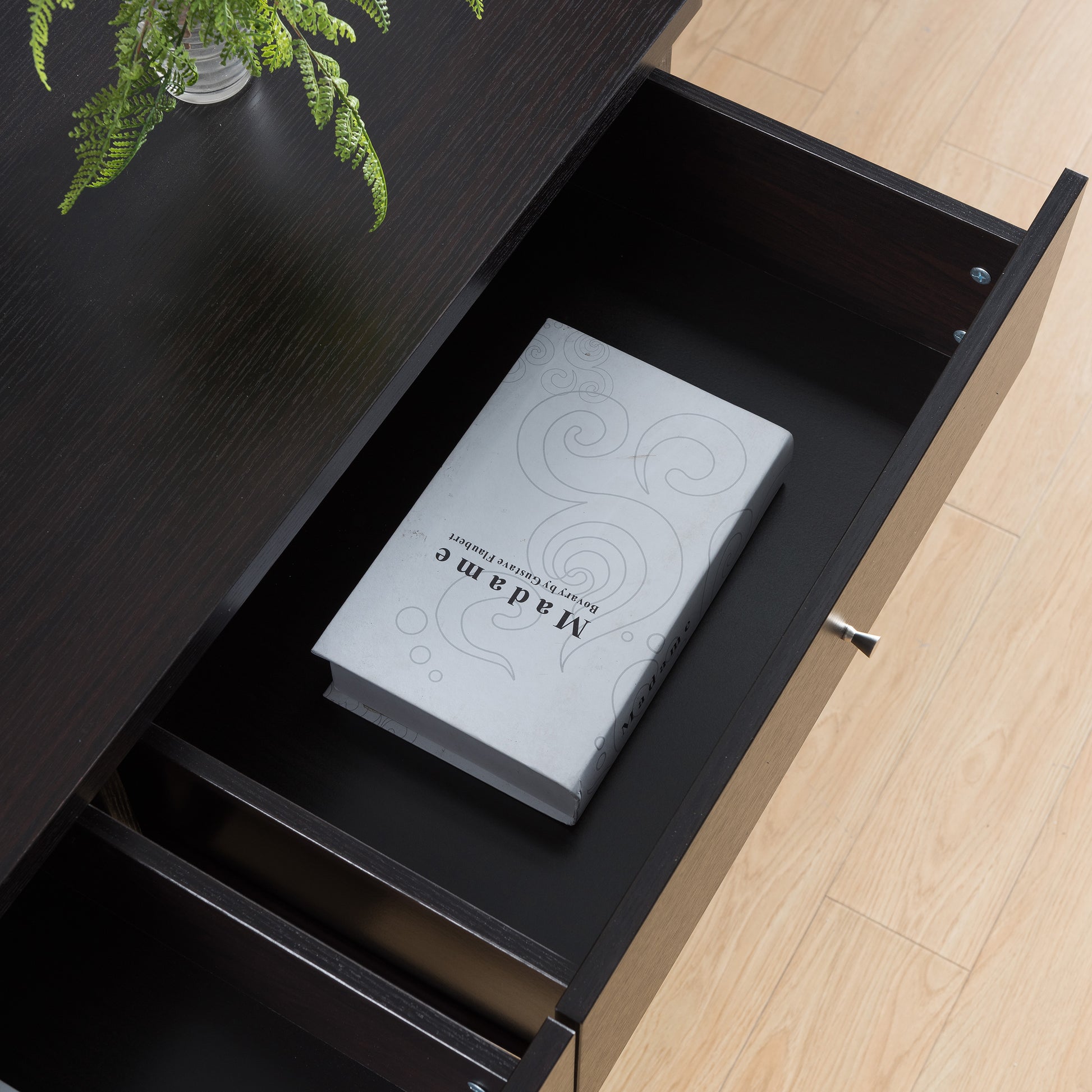 Right angled bird's eye close-up view of a mid-century modern cappuccino six-drawer dresser with top drawers open in a bedroom with accessories