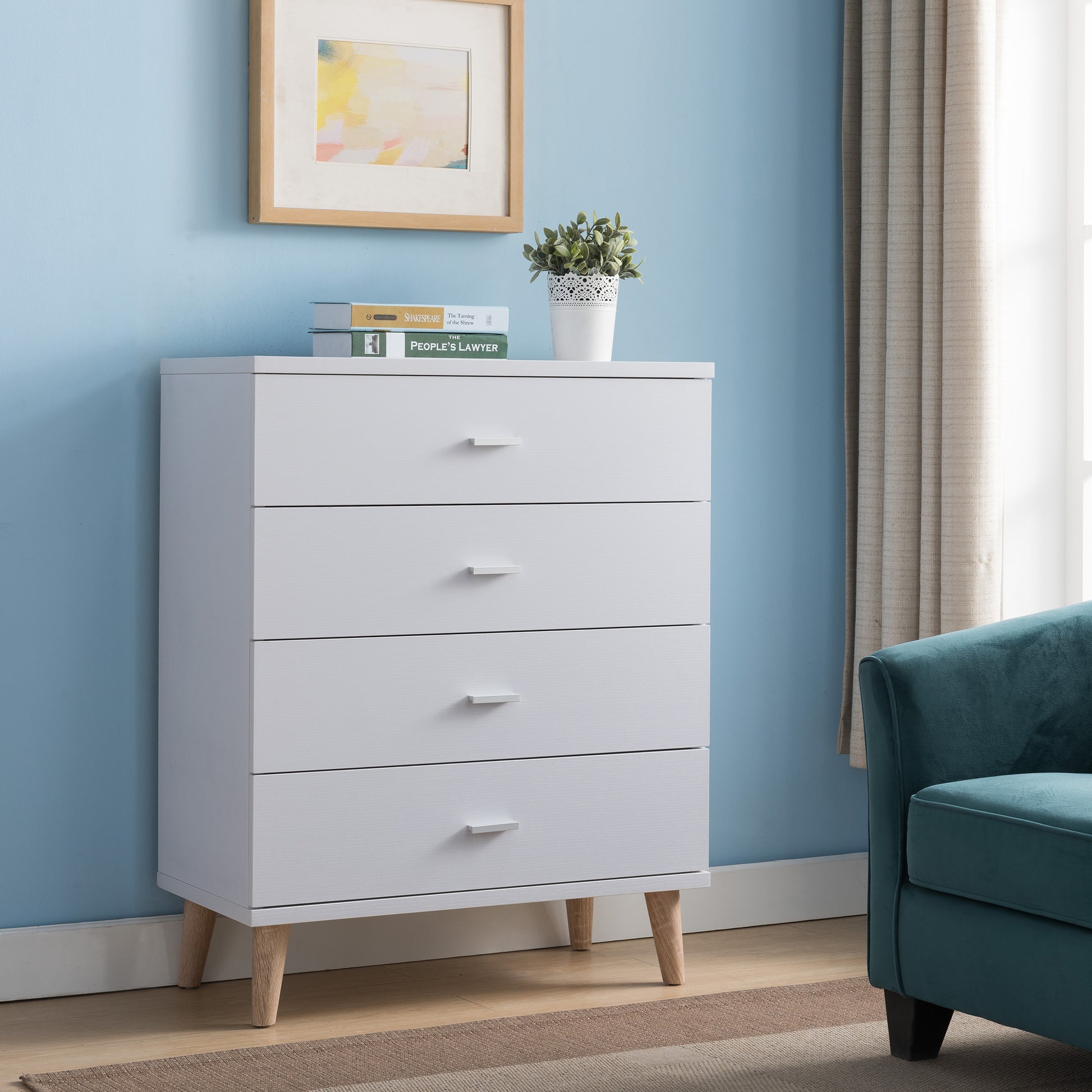 Right angled mid-century modern white four-drawer chest dresser in a bedroom with accessories