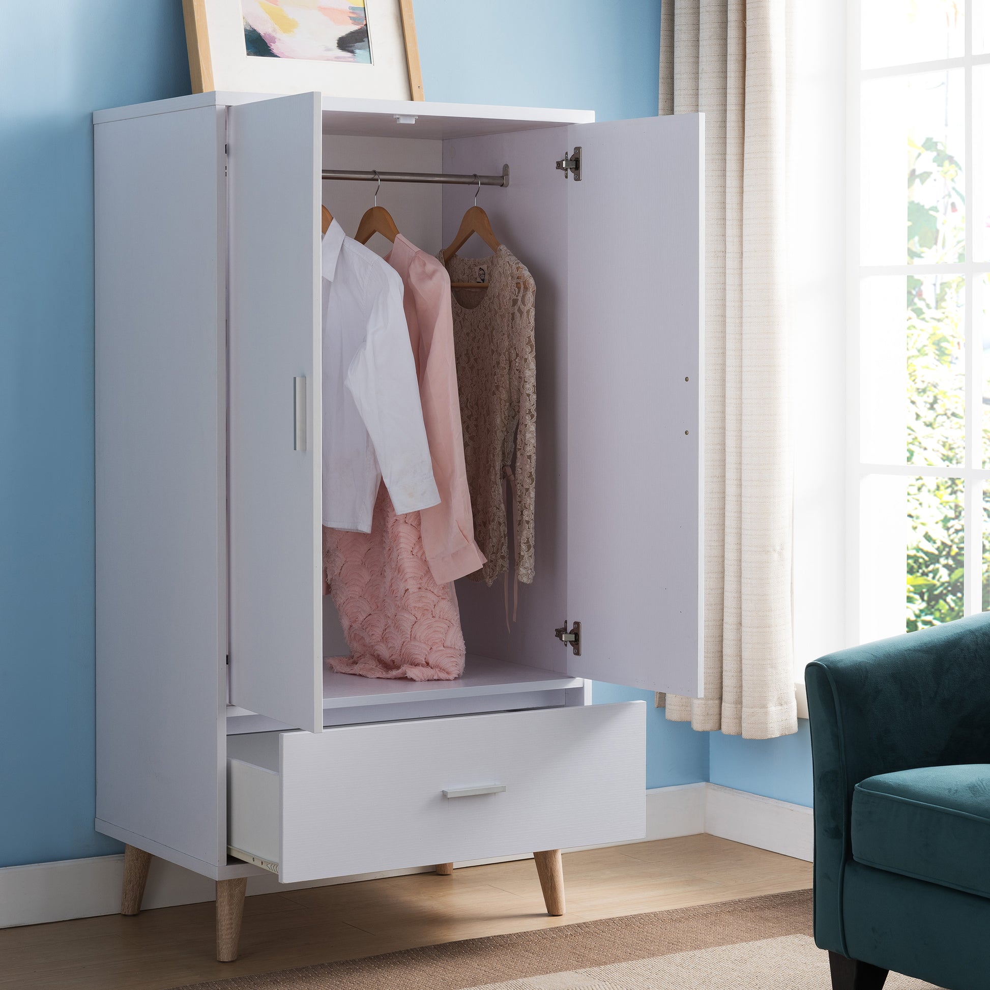 Right angled mid-century modern white two-door one-drawer wardrobe armoire with doors and drawer open in a bedroom with accessories