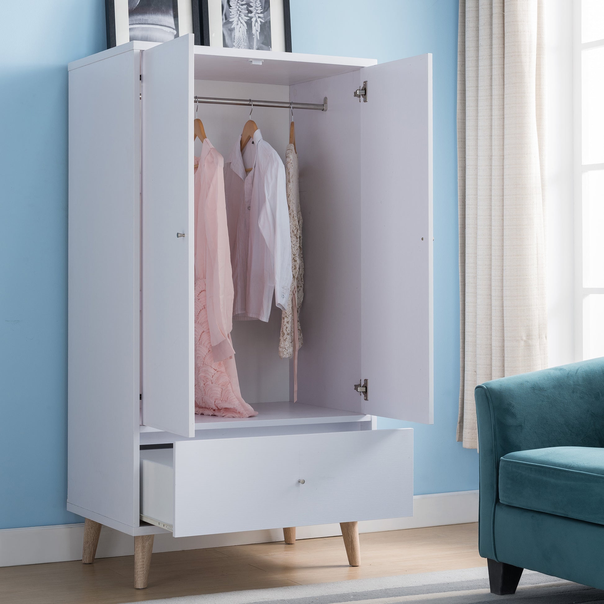 Right angled mid-century modern white two-door one-drawer wardrobe armoire with doors and drawer open in a bedroom with accessories