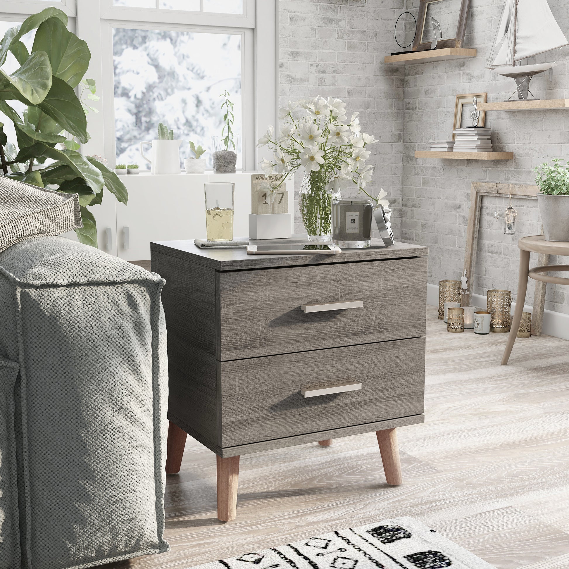 Right angled mid-century modern distressed gray two-drawer nightstand in a living area with accessories
