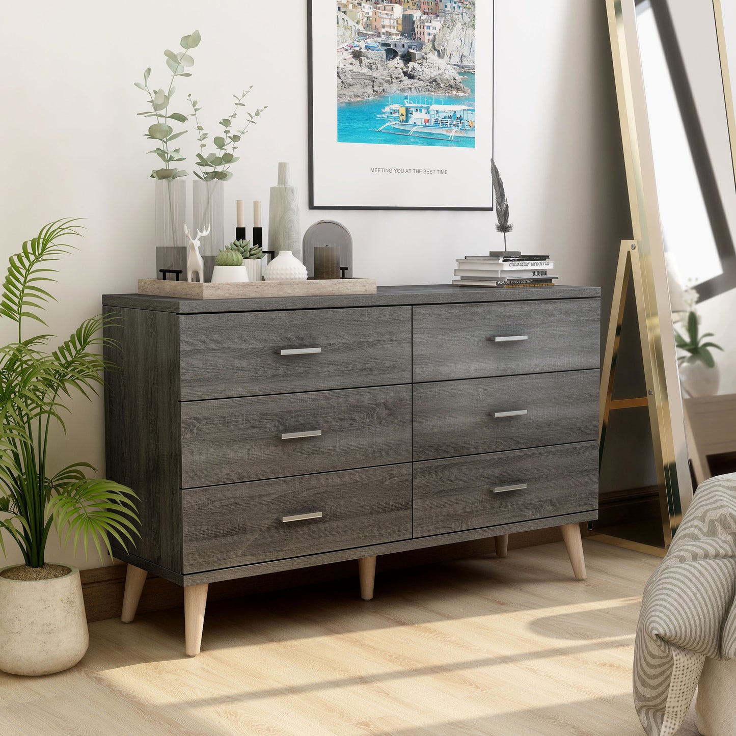 Right angled mid-century modern distressed gray six-drawer dresser in a bedroom with accessories