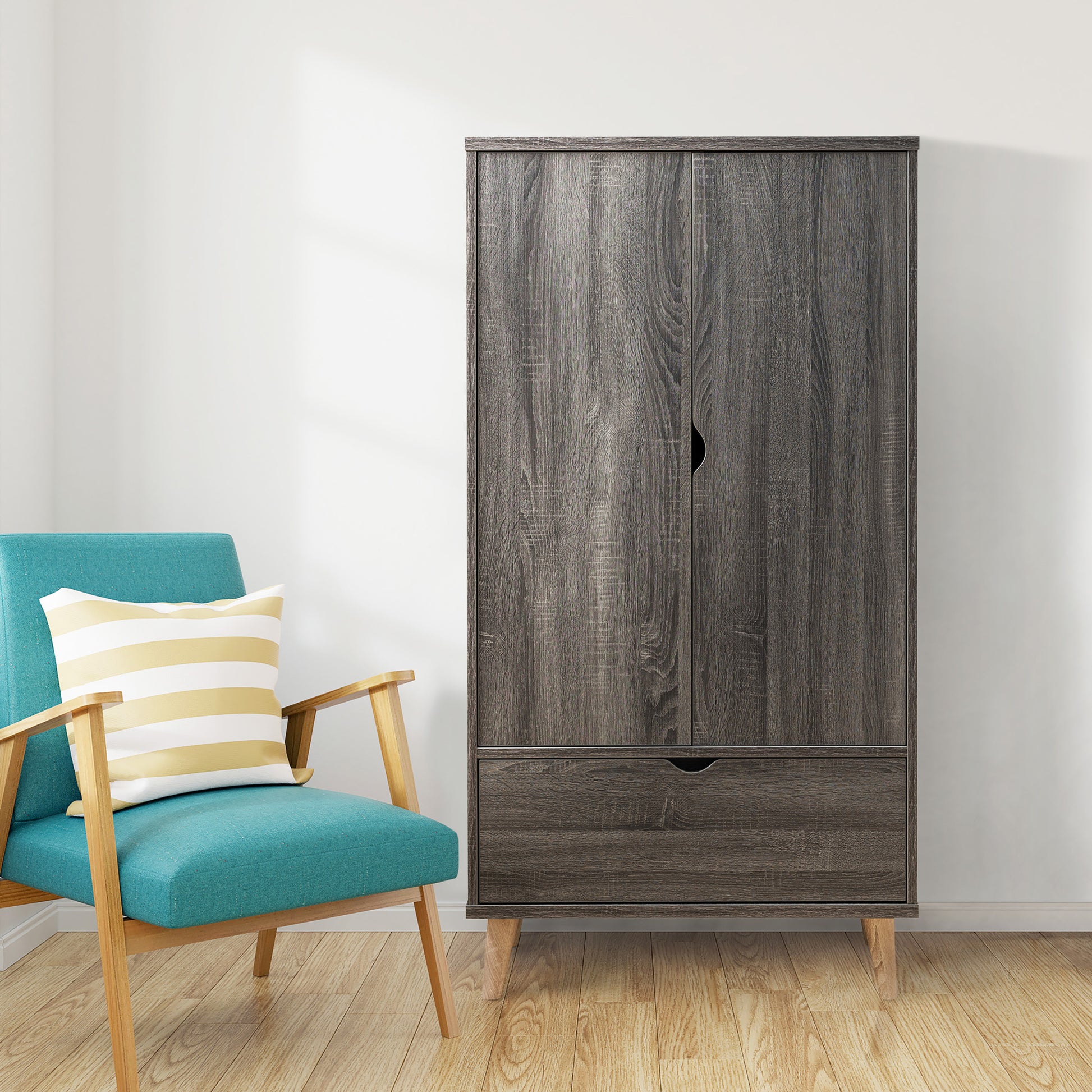 Front-facing mid-century modern distressed gray two-door one-drawer wardrobe armoire in a living area with accessories