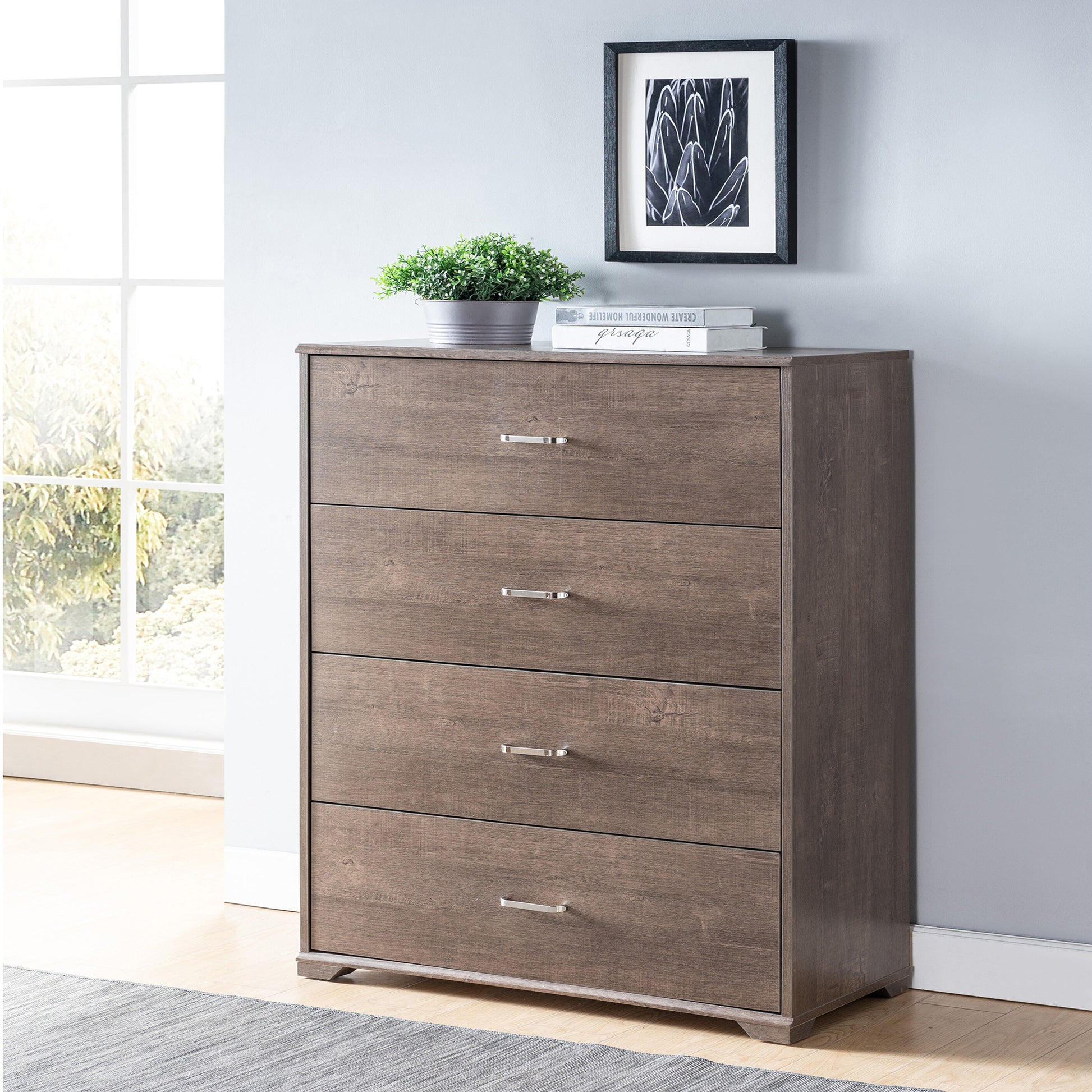 Left angled contemporary walnut four-drawer chest dresser in a bedroom with accessories