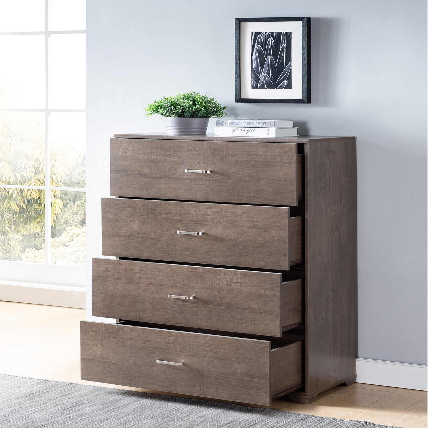 Left angled contemporary walnut four-drawer chest dresser with all drawers open in a bedroom with accessories