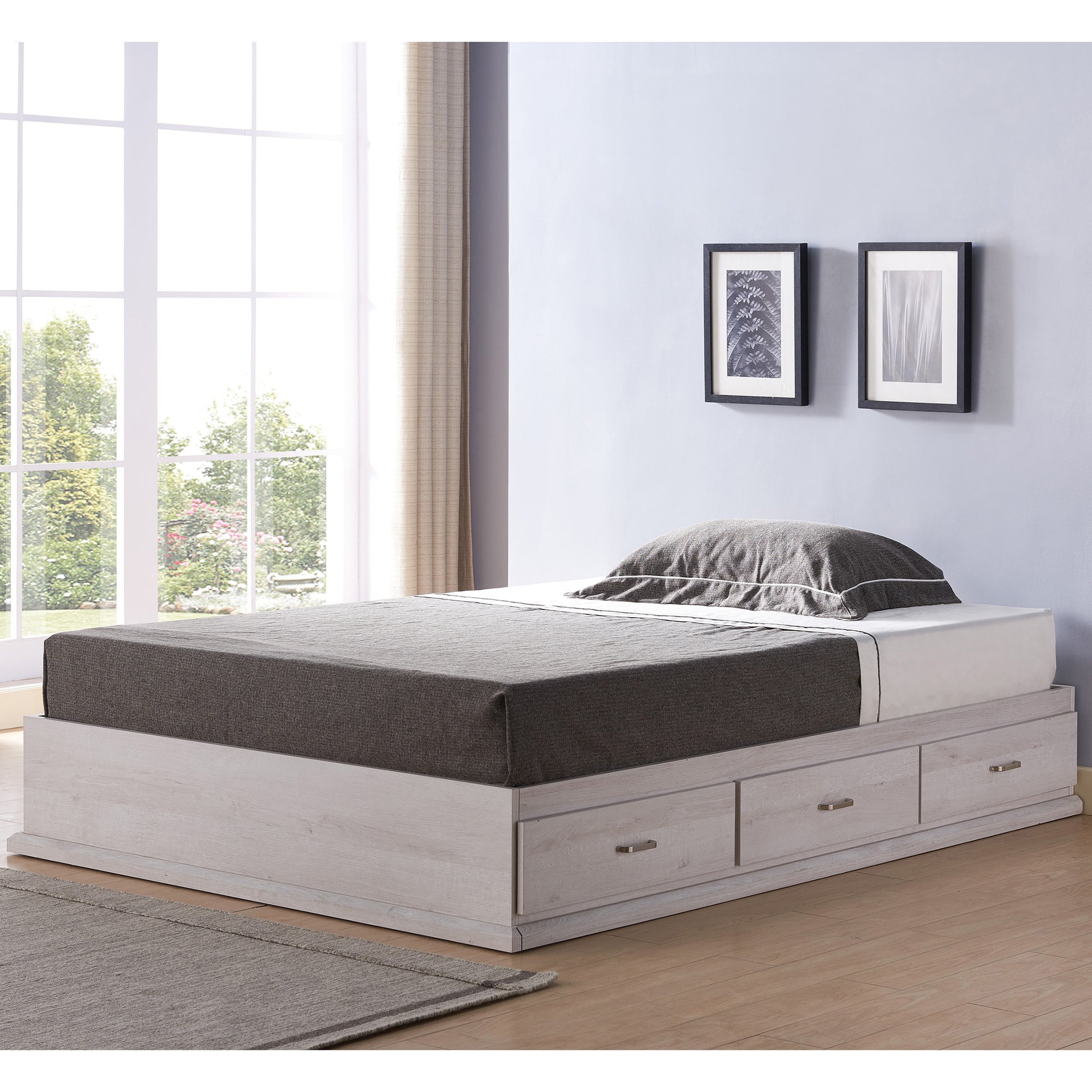 Left angled contemporary white oak three-drawer platform storage bed in a bedroom with accessories