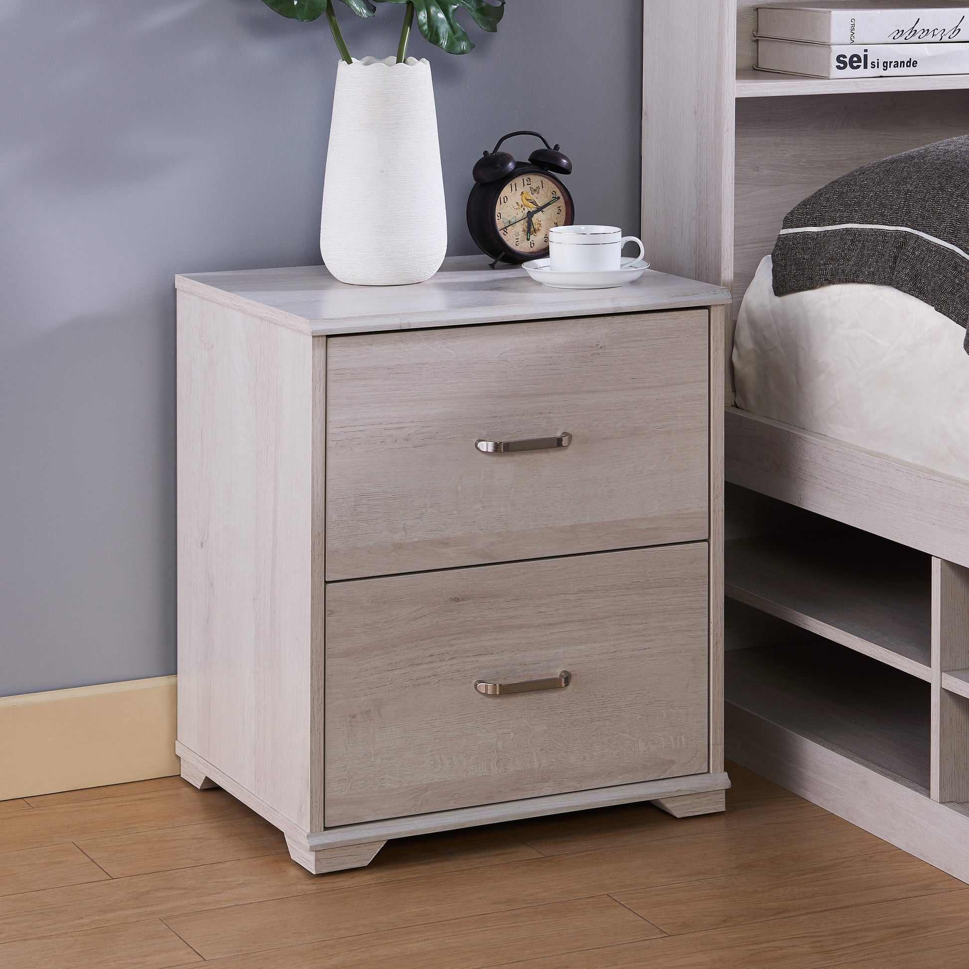 Right angled transitional white oak two-drawer nightstand in a bedroom with accessories