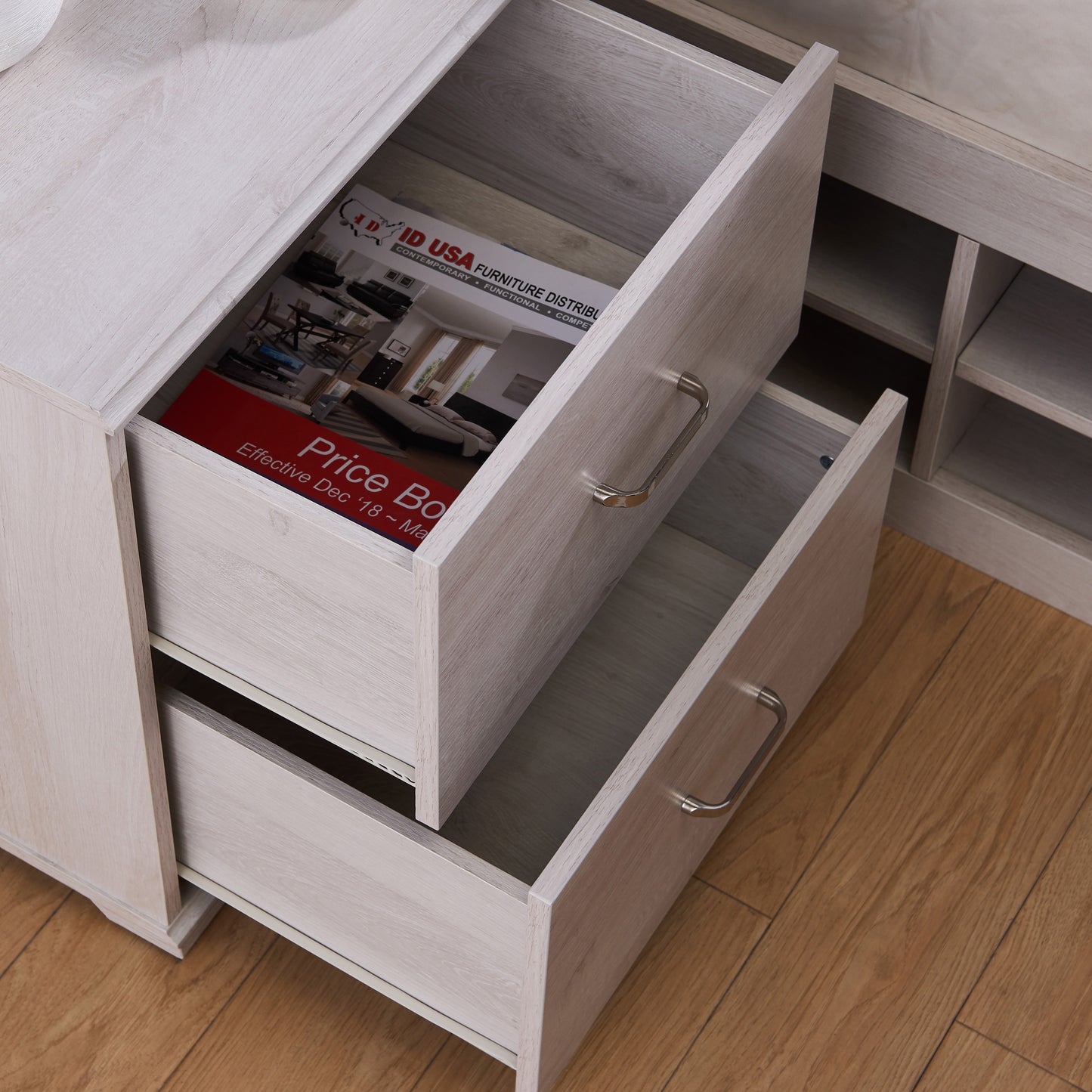 Right angled bird's eye view of a transitional white oak two-drawer nightstand with drawers open in a bedroom with accessories