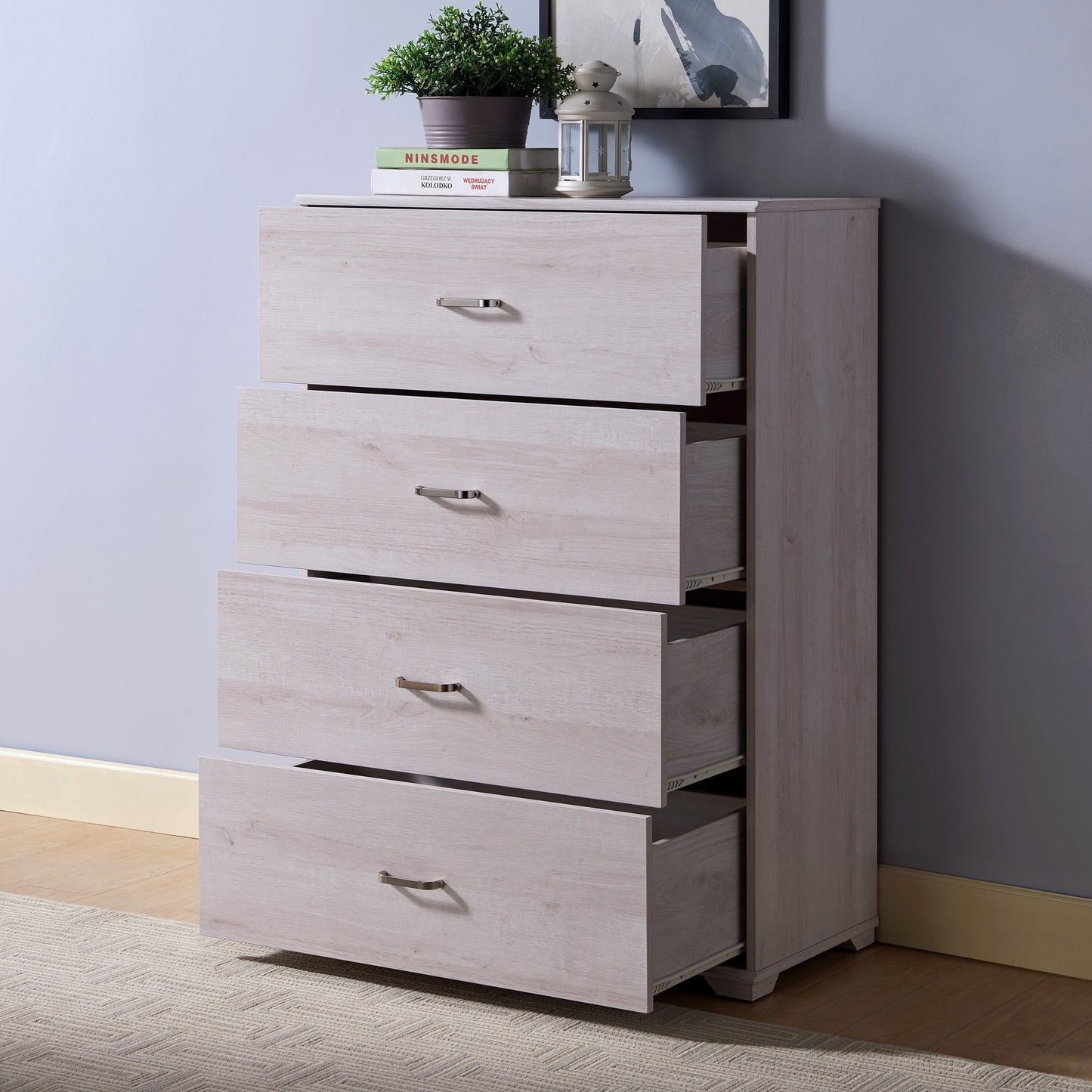 Left angled contemporary white oak four-drawer chest dresser with all drawers open with a rug and accessories