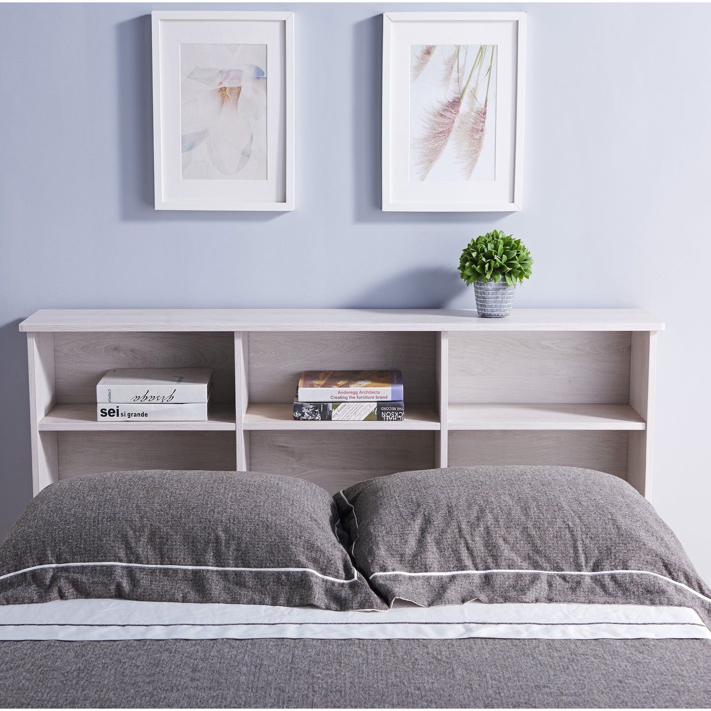 Front-facing transitional white oak six-shelf bookcase headboard shown with a bed in a bedroom with accessories