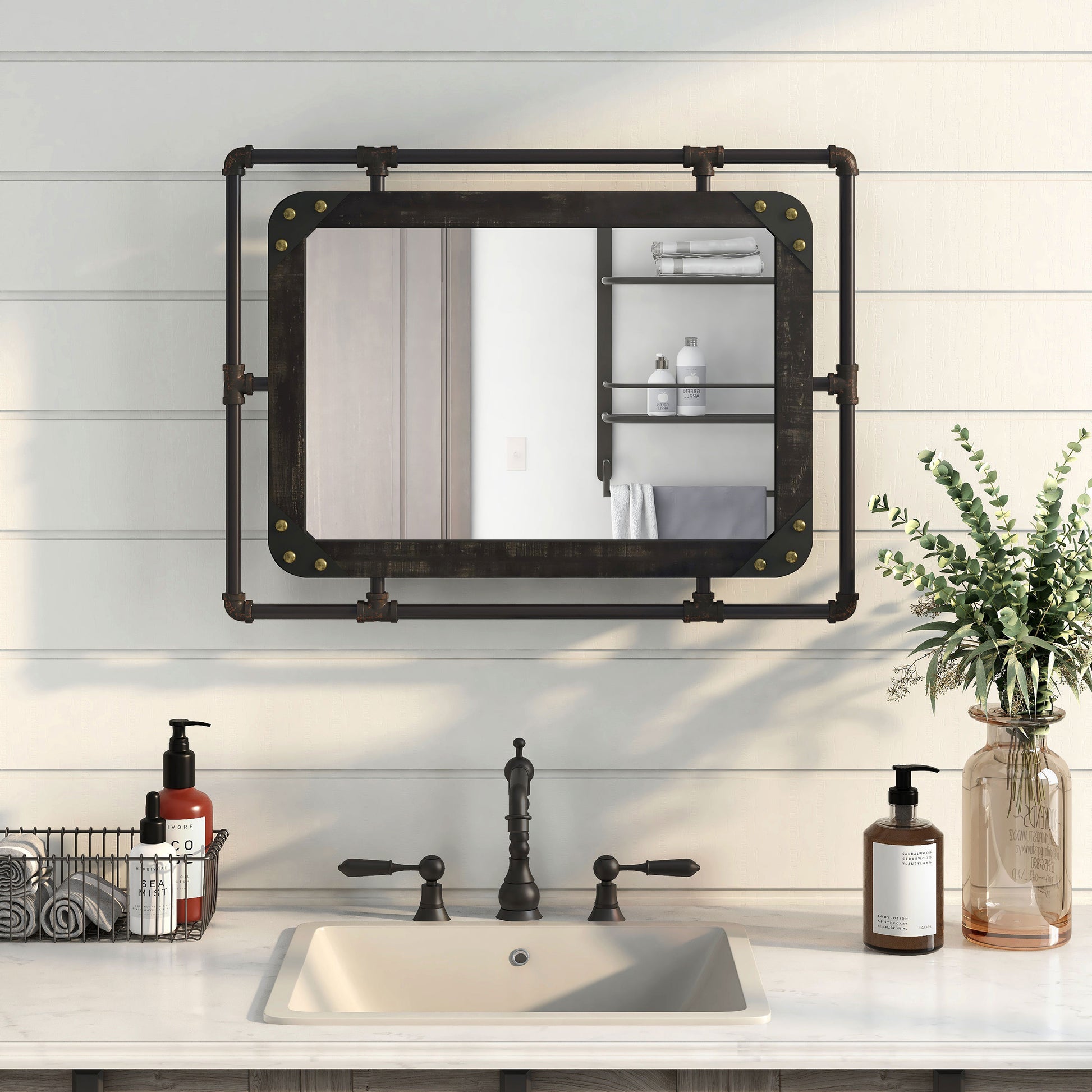 Front-facing industrial reclaimed black oak and water pipe wall mirror over a vanity with accessories