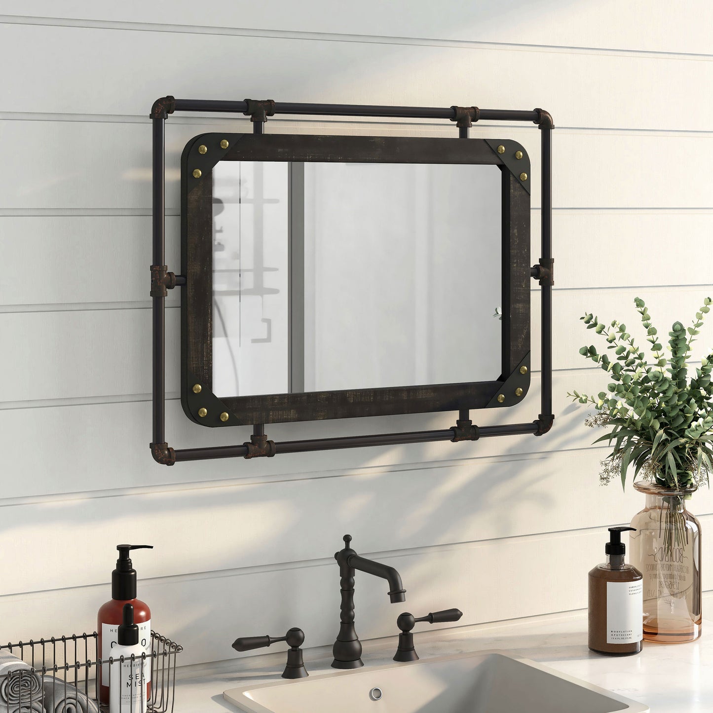 Right angled industrial reclaimed black oak and water pipe wall mirror over a vanity with accessories