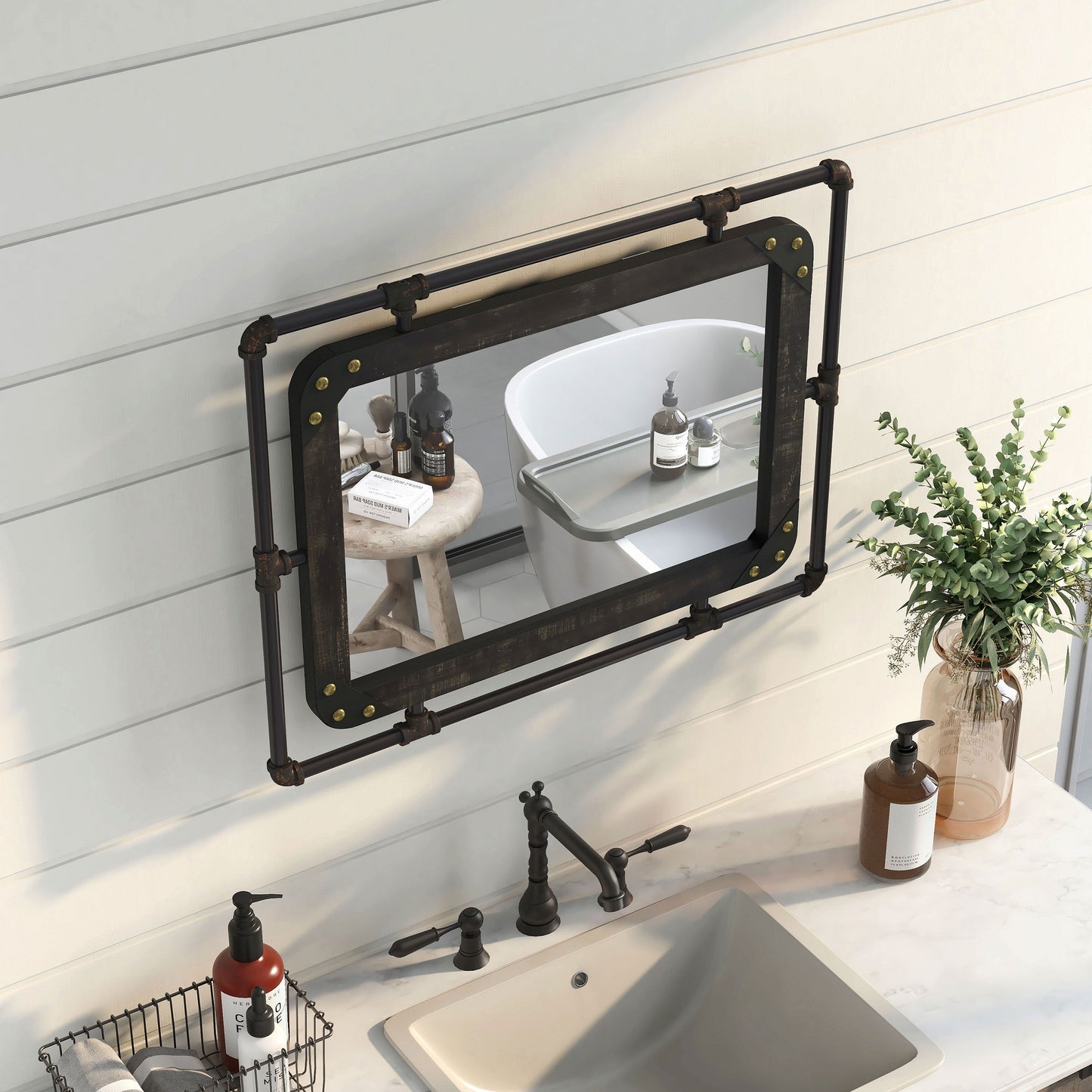 Right angled bird's eye view of an industrial reclaimed black oak and water pipe wall mirror over a vanity with accessories
