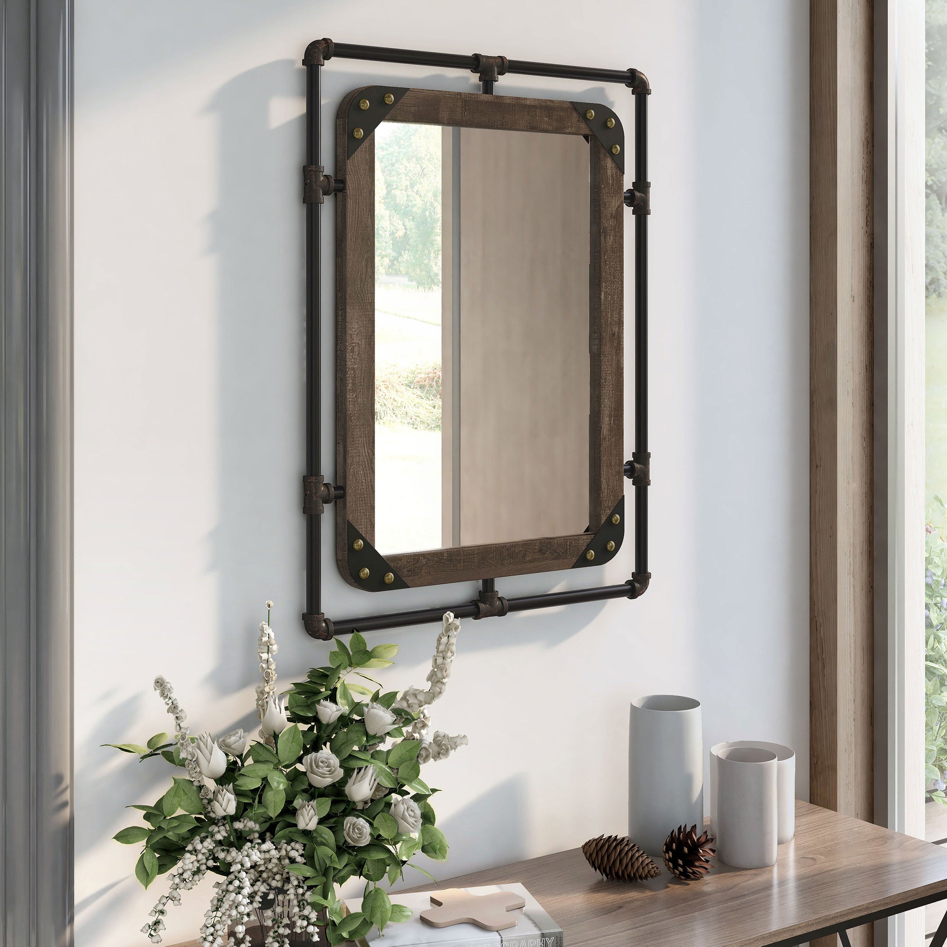 Right angled industrial reclaimed oak and water pipe wall mirror over a console with accessories