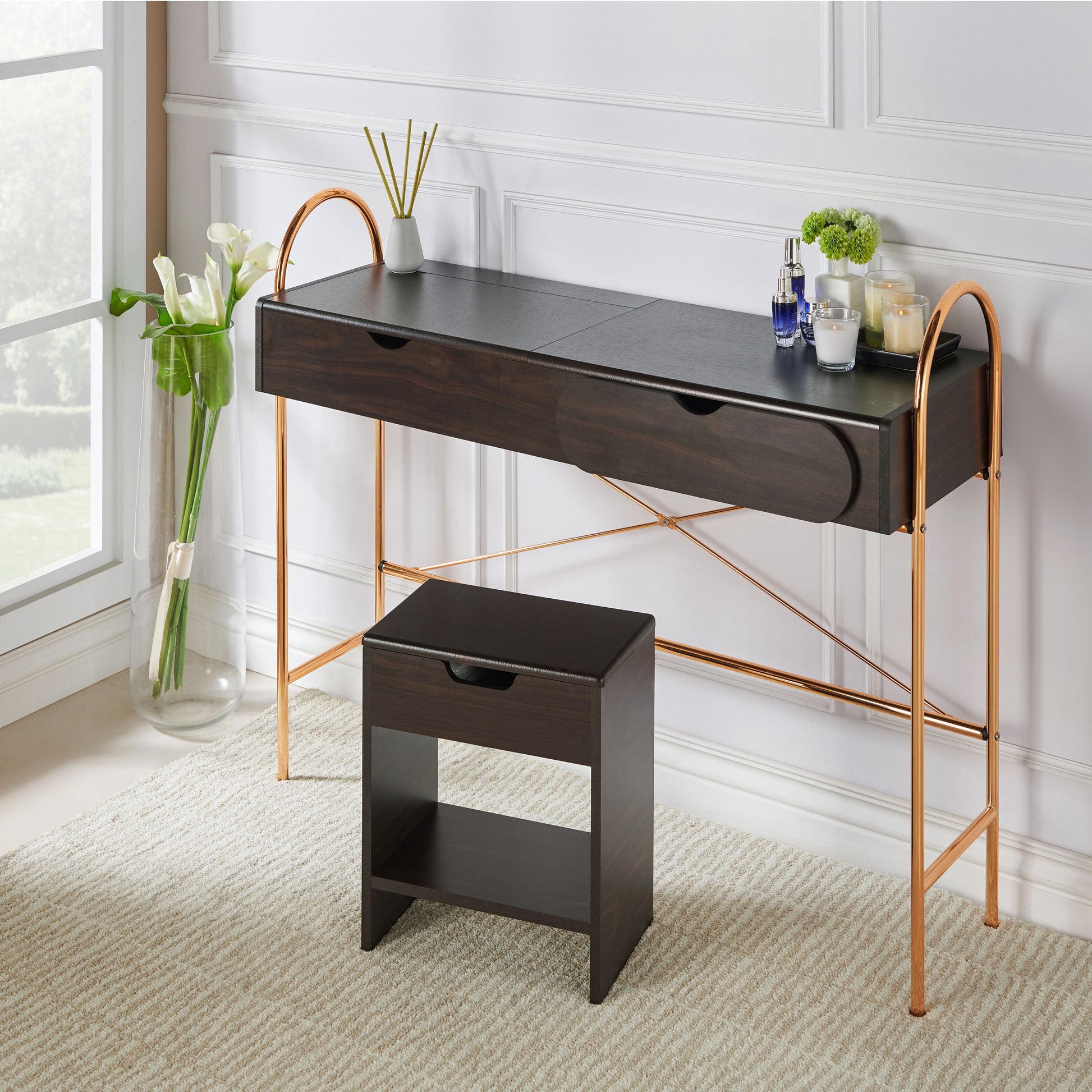 Left angled modern glam walnut and gold lift-top vanity table with a mirror in a living area with accessories