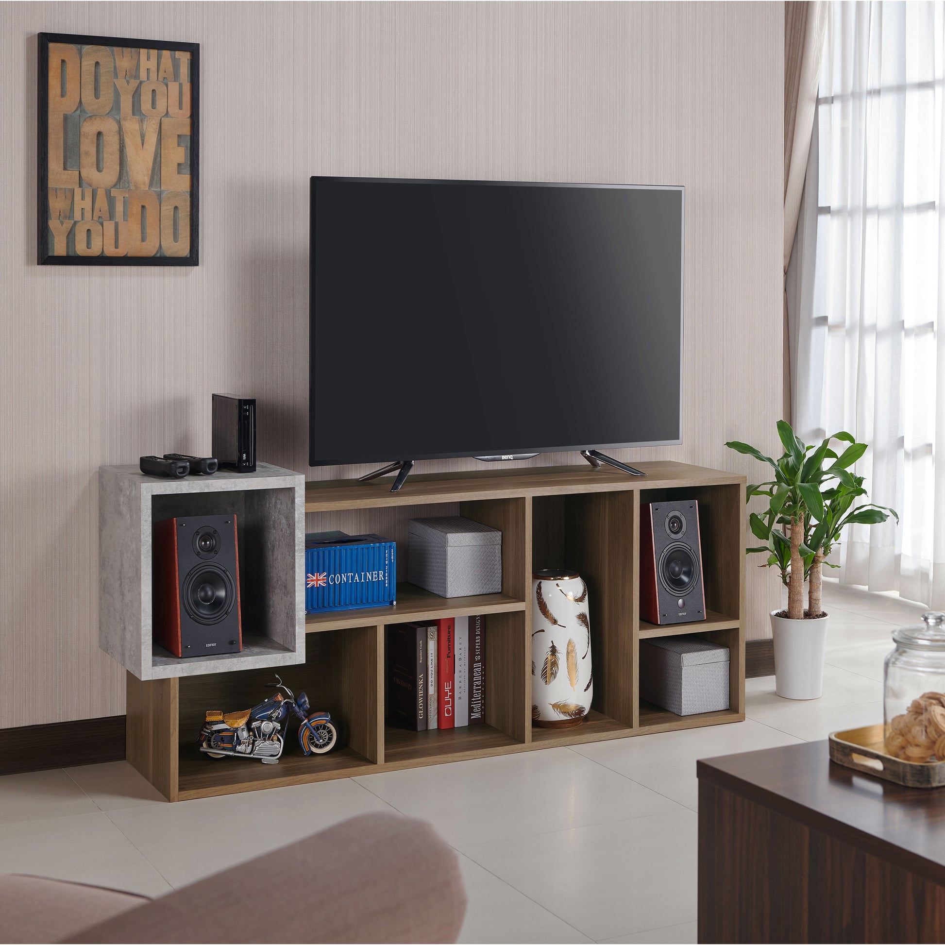 Right angled transitional honey walnut and concrete seven-shelf bookcase shown as a TV stand in a living room with accessories