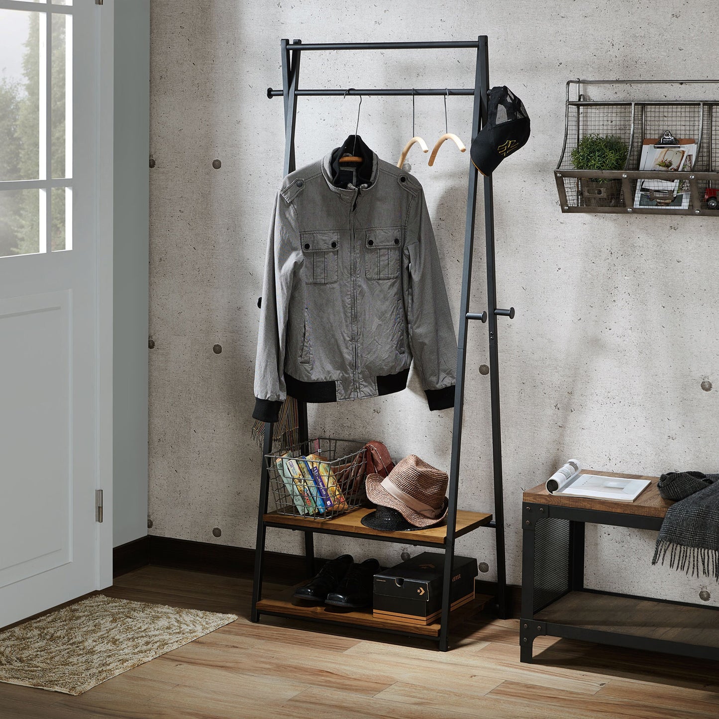Left angled industrial warm oak and black two-shelf six-hook coat rack in an entry with accessories
