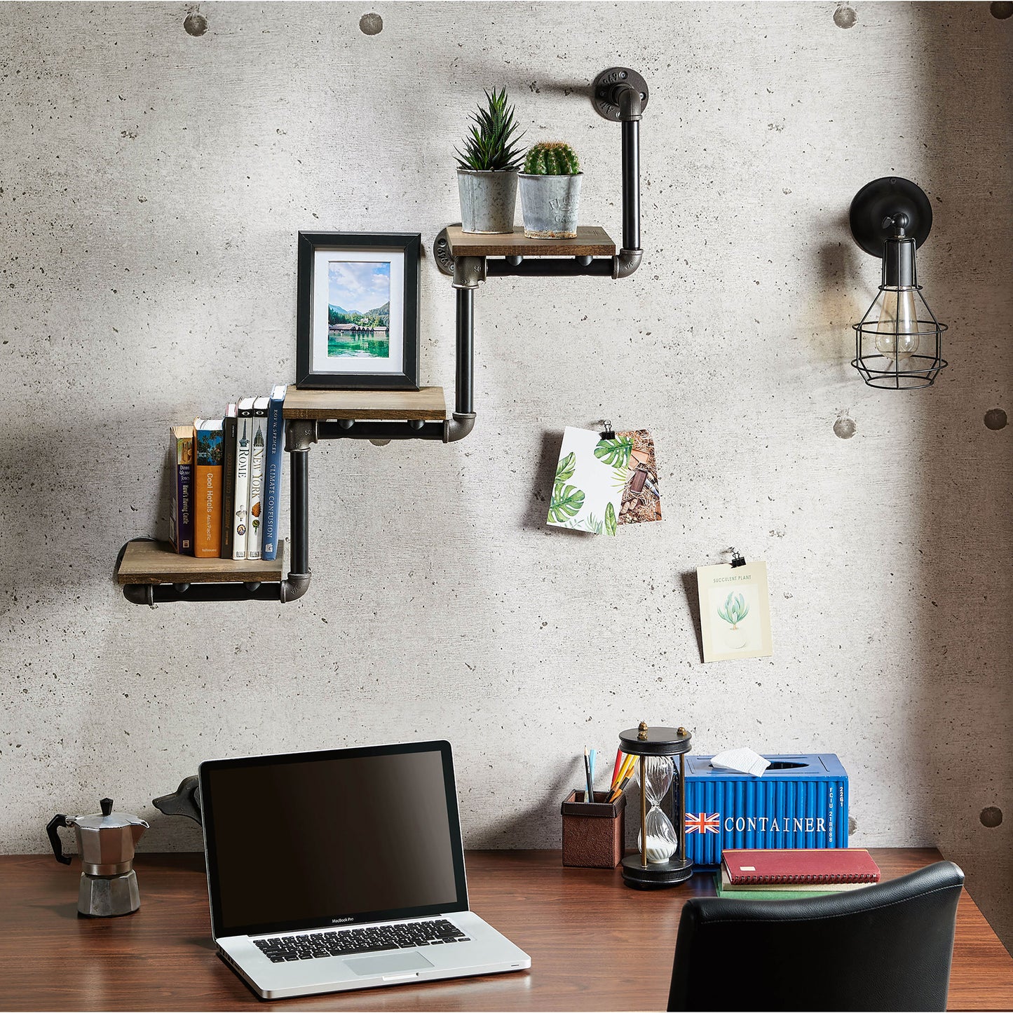 Front-facing industrial reclaimed oak three-tier water pipe wall shelf in a home office with accessories