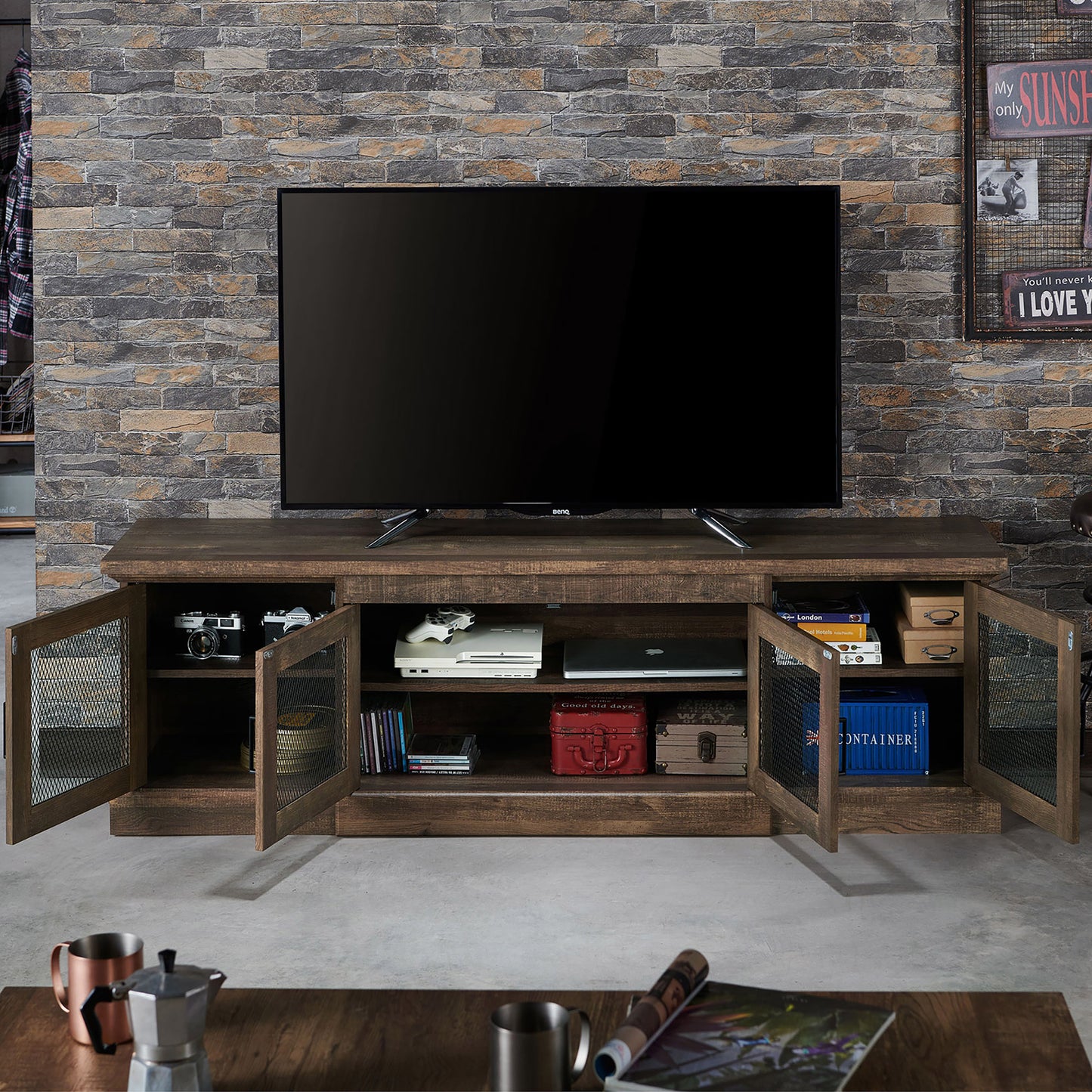 Front-facing rustic reclaimed oak six-shelf TV stand with mesh doors open in a living room with accessories