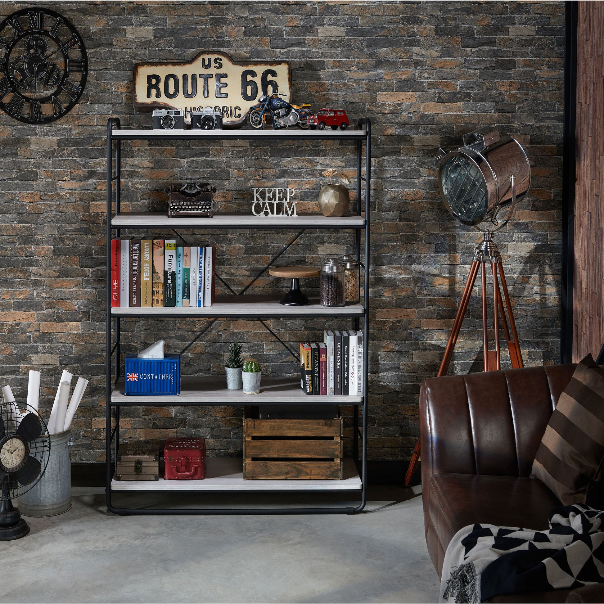 Front-facing rustic coastal white and black five-shelf open bookcase in a living area with accessories