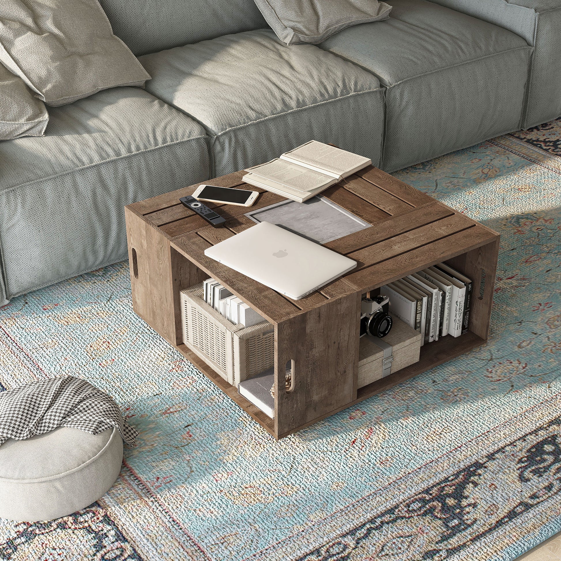 Right angled bird's eye view of a rustic reclaimed oak crate-style mobile storage coffee table in a living room with accessories