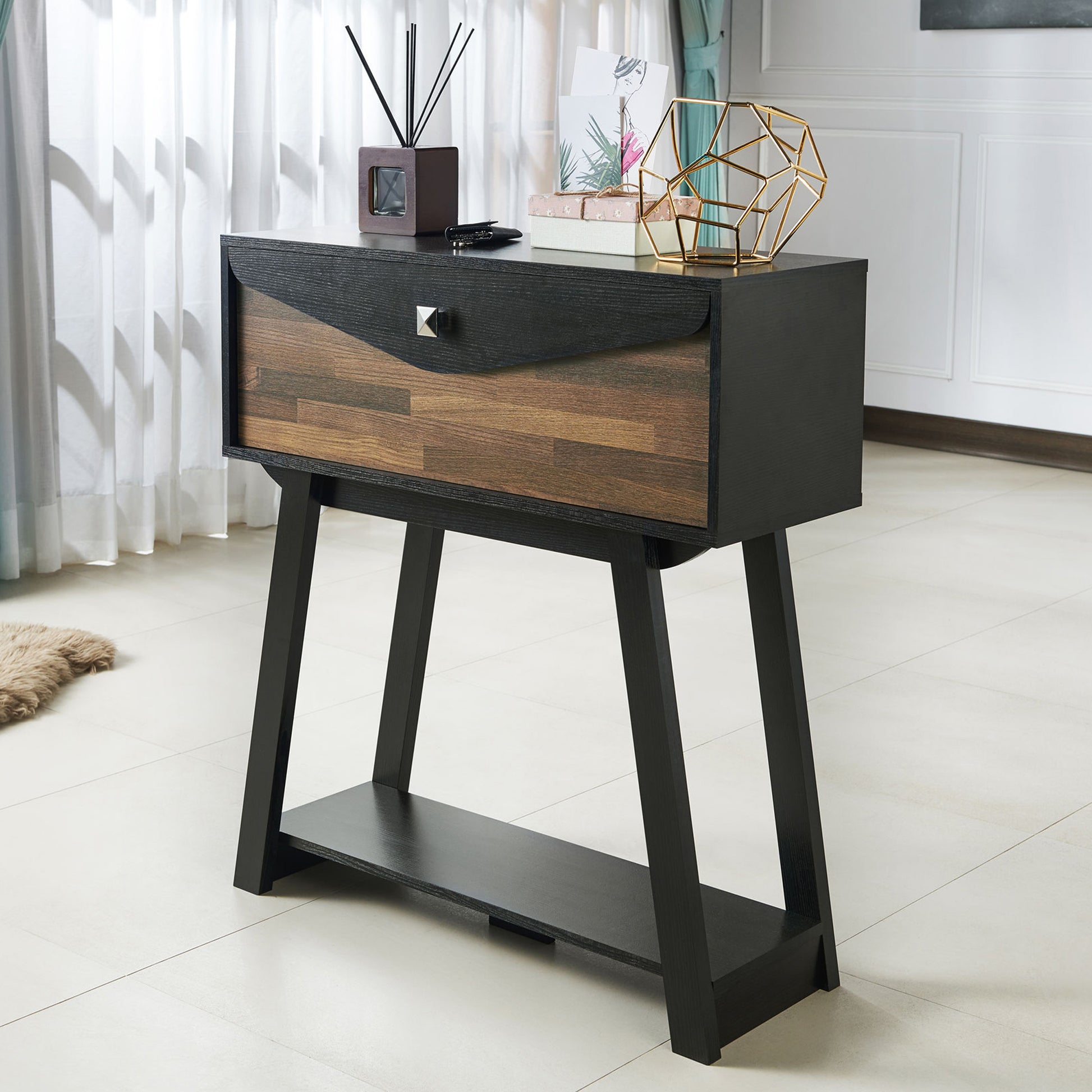 Left angled modern black and wood one-drawer console table with a shelf in a living room with accessories