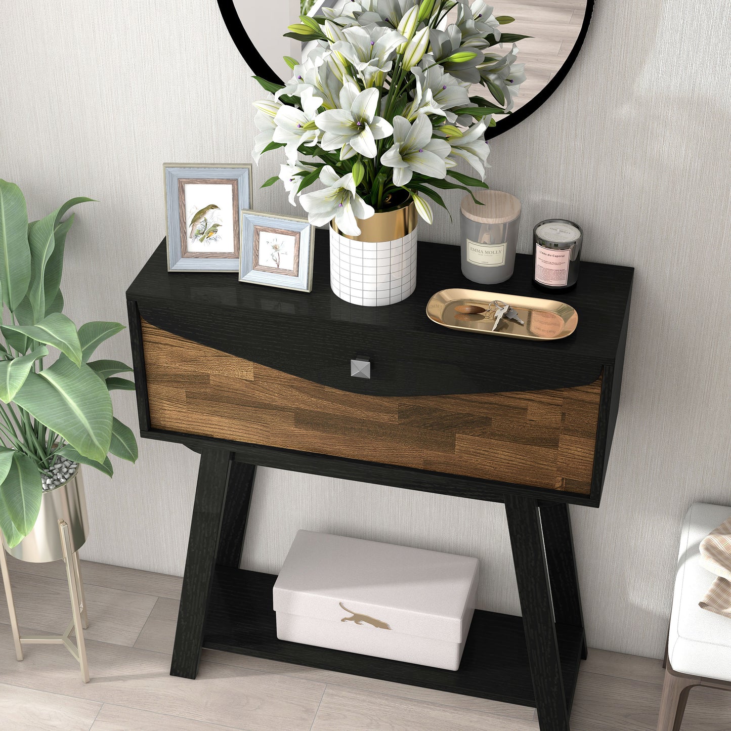 Left angled bird's eye view of a modern black and wood one-drawer console table with a shelf in a living room with accessories