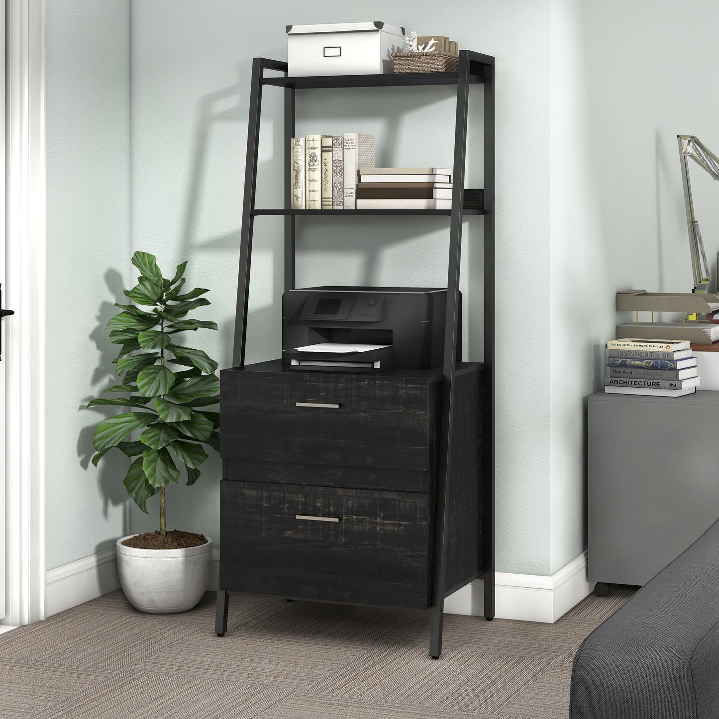 Left angled contemporary reclaimed black oak and black angular two-shelf bookcase with two-drawer file cabinet in a home office with accessories