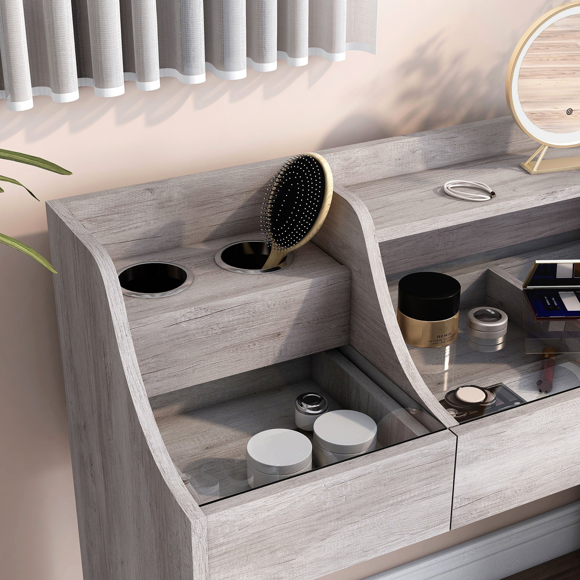 Right angled bird's eye close-up view of a transitional coastal white three-drawer vanity table with grommets and glass drawer tops in a bedroom with accessories