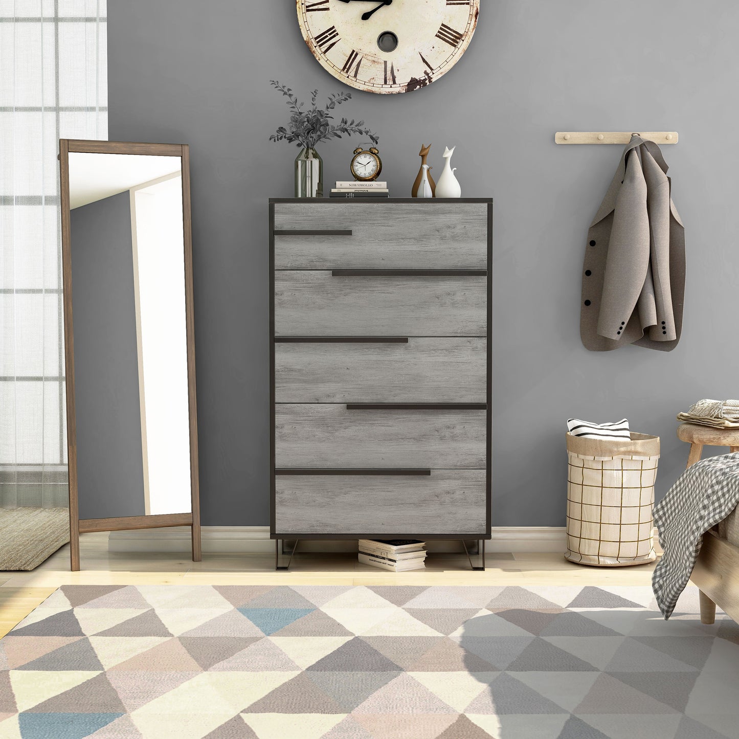 Front-facing modern vintage gray oak and black five-drawer chest in a bedroom with accessories