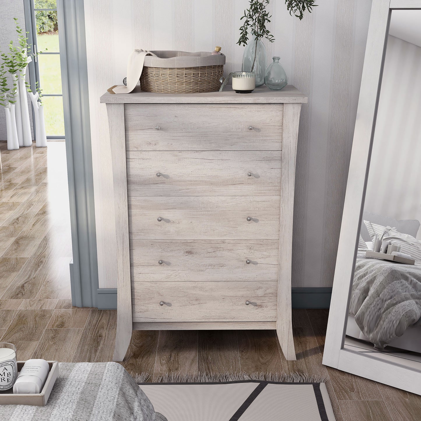 Front-facing transitional coastal white five-drawer chest in a bedroom with accessories