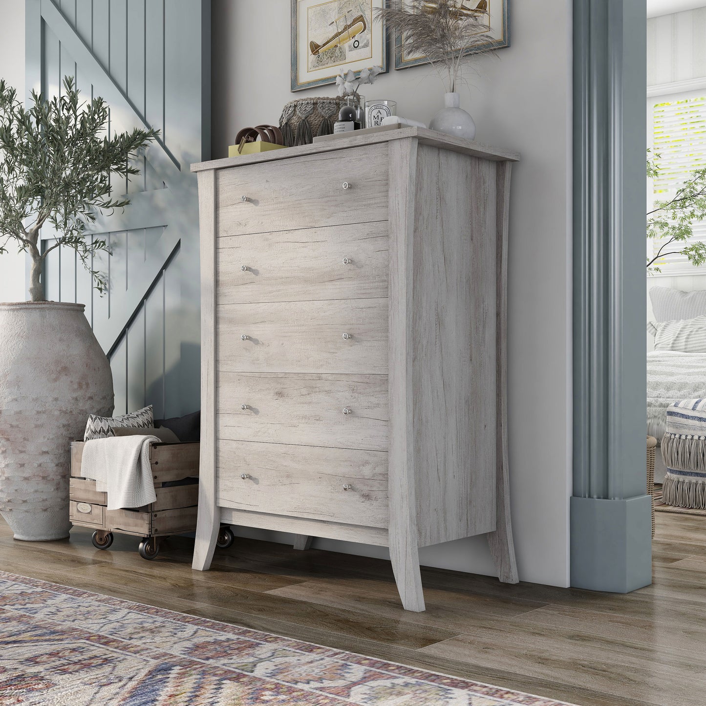 Left angled transitional coastal white five-drawer chest in a living area with accessories