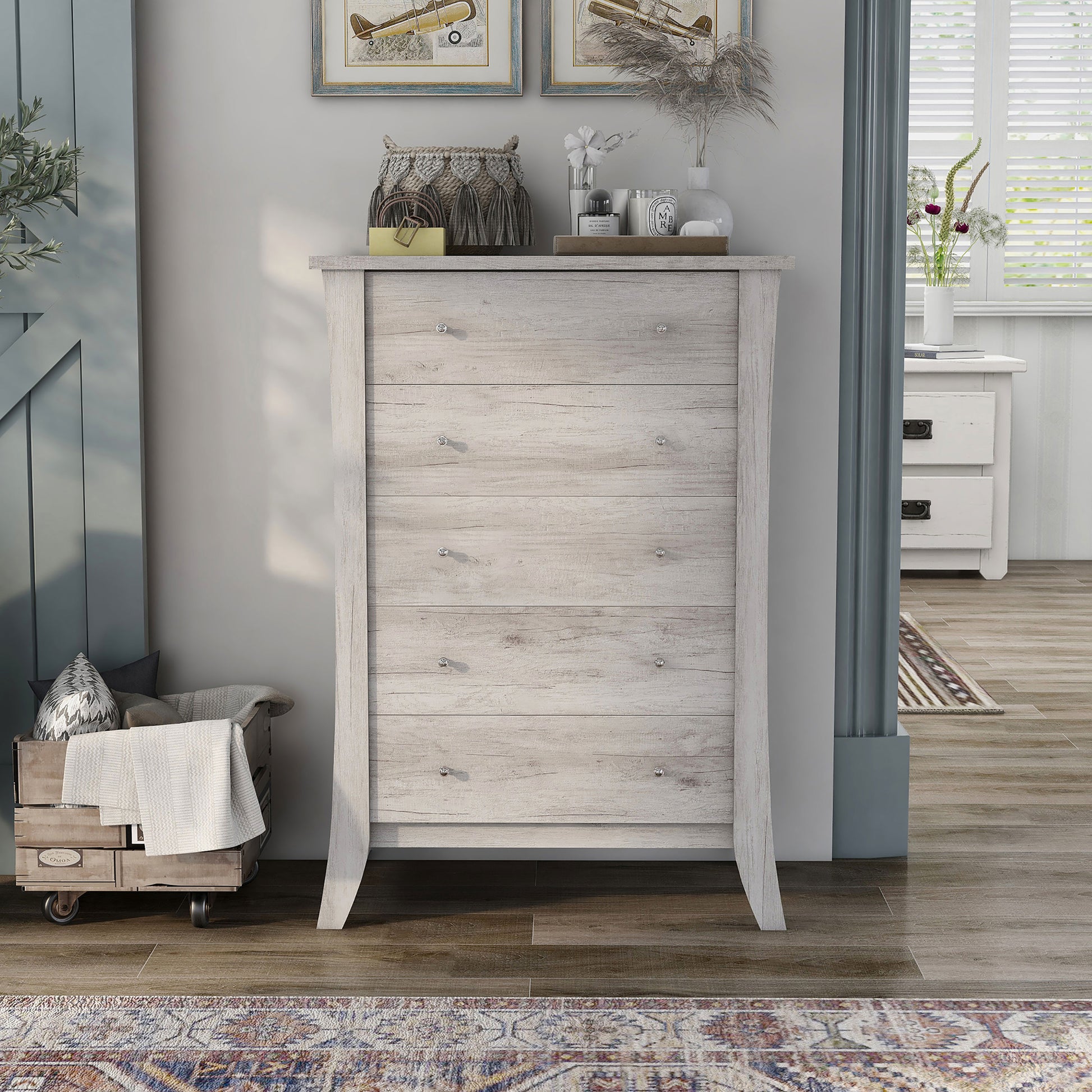 Front-facing transitional coastal white five-drawer chest in a living area with accessories