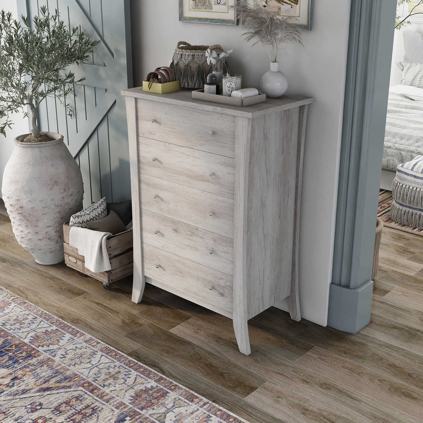 Left angled bird's eye view of a transitional coastal white five-drawer chest in a living area with accessories