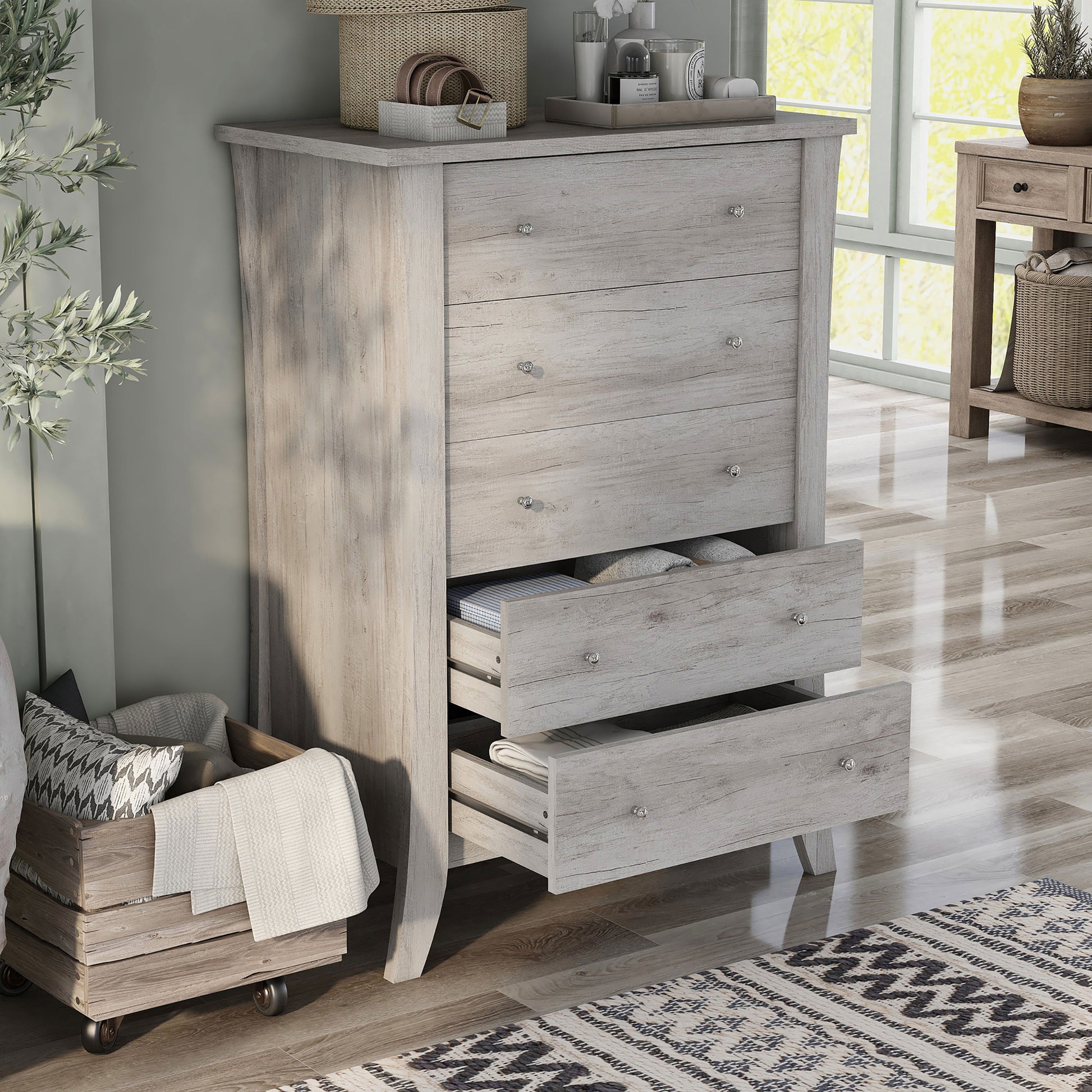 Right angled transitional coastal white five-drawer chest with two drawers open in a living area with accessories