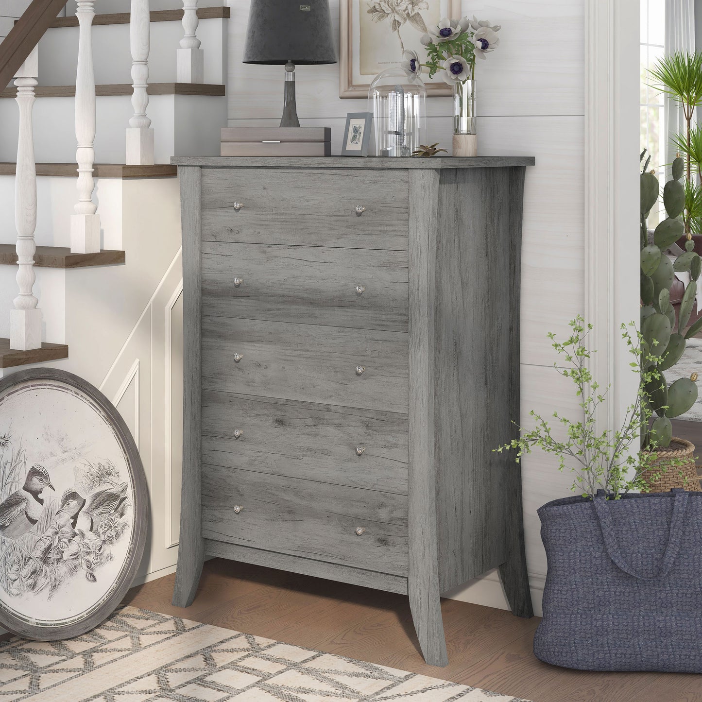 Left angled transitional vintage gray oak five-drawer chest in a living area with accessories