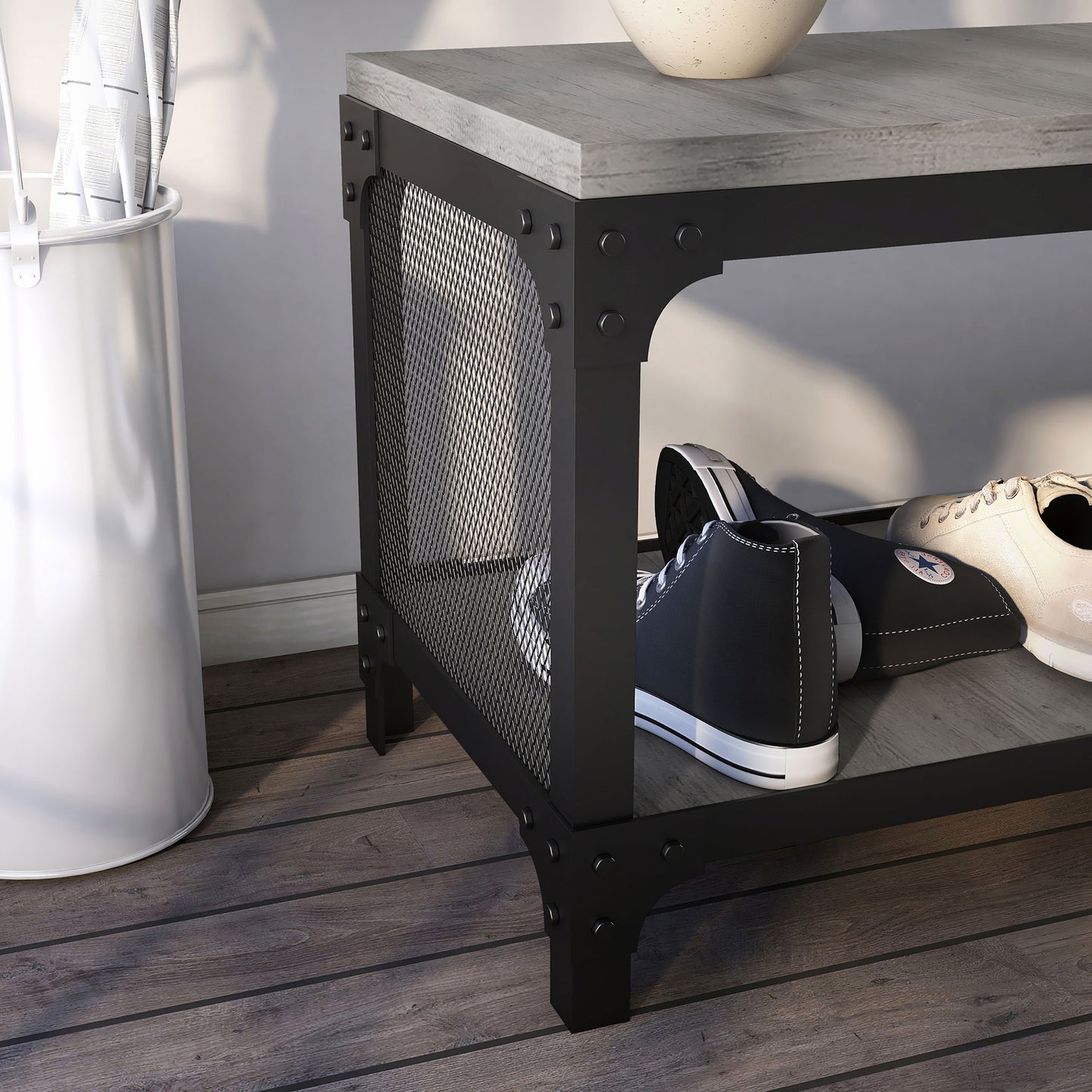 Right angled close-up mesh side detail view of an industrial vintage gray oak shoe storage bench with a shelf in an entry with accessories