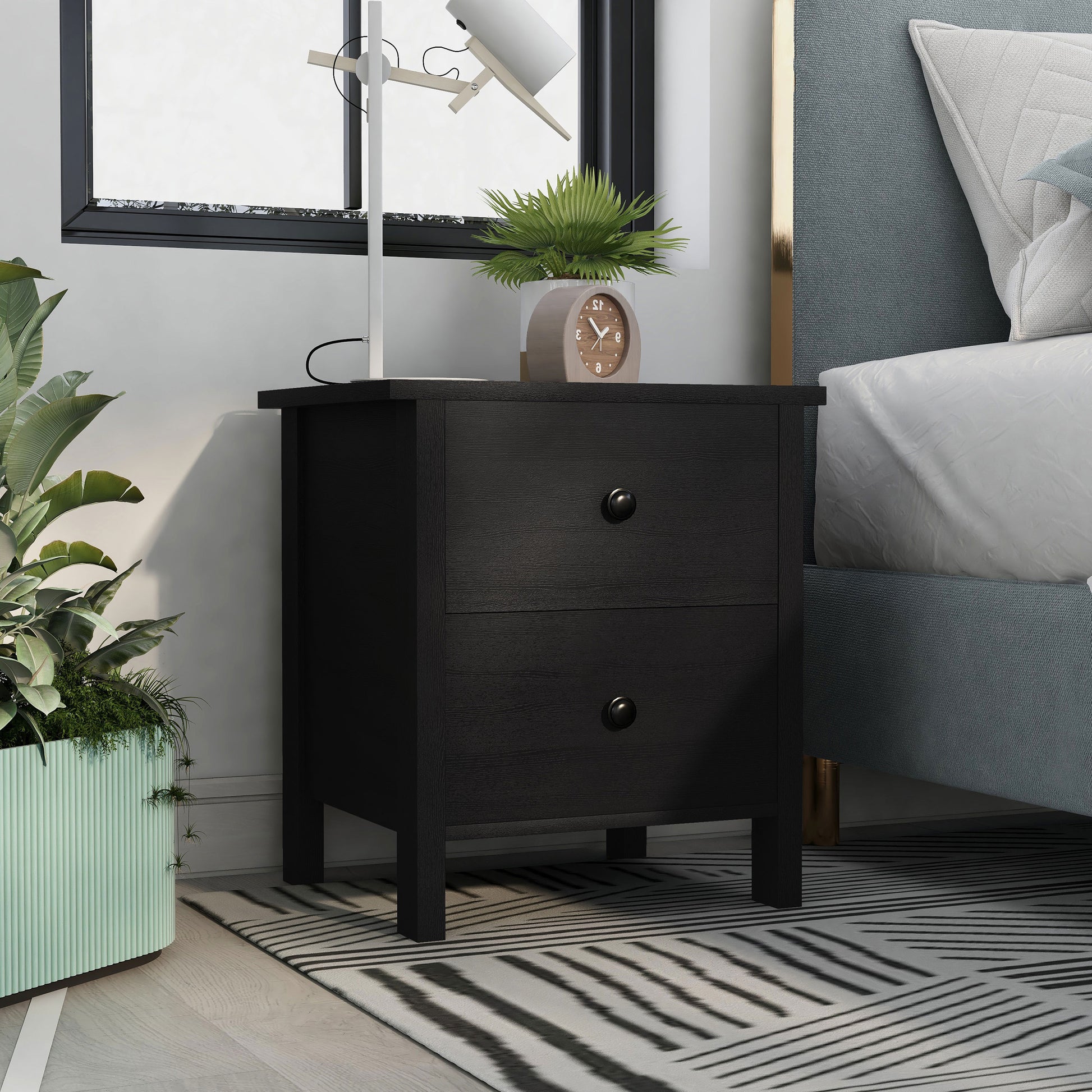 Right angled transitional black two-drawer nightstand in a bedroom with accessories