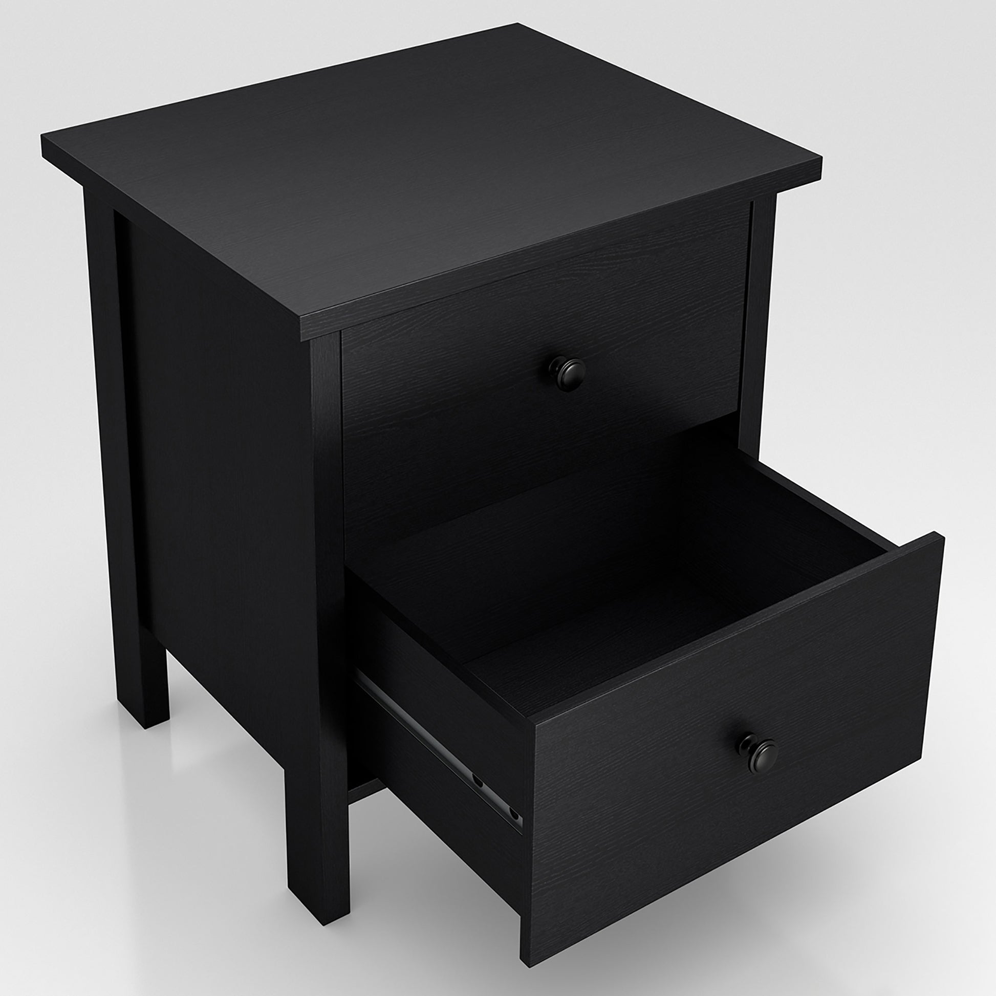 Right angled upper view of a transitional black two-drawer nightstand with bottom drawer open on a white background
