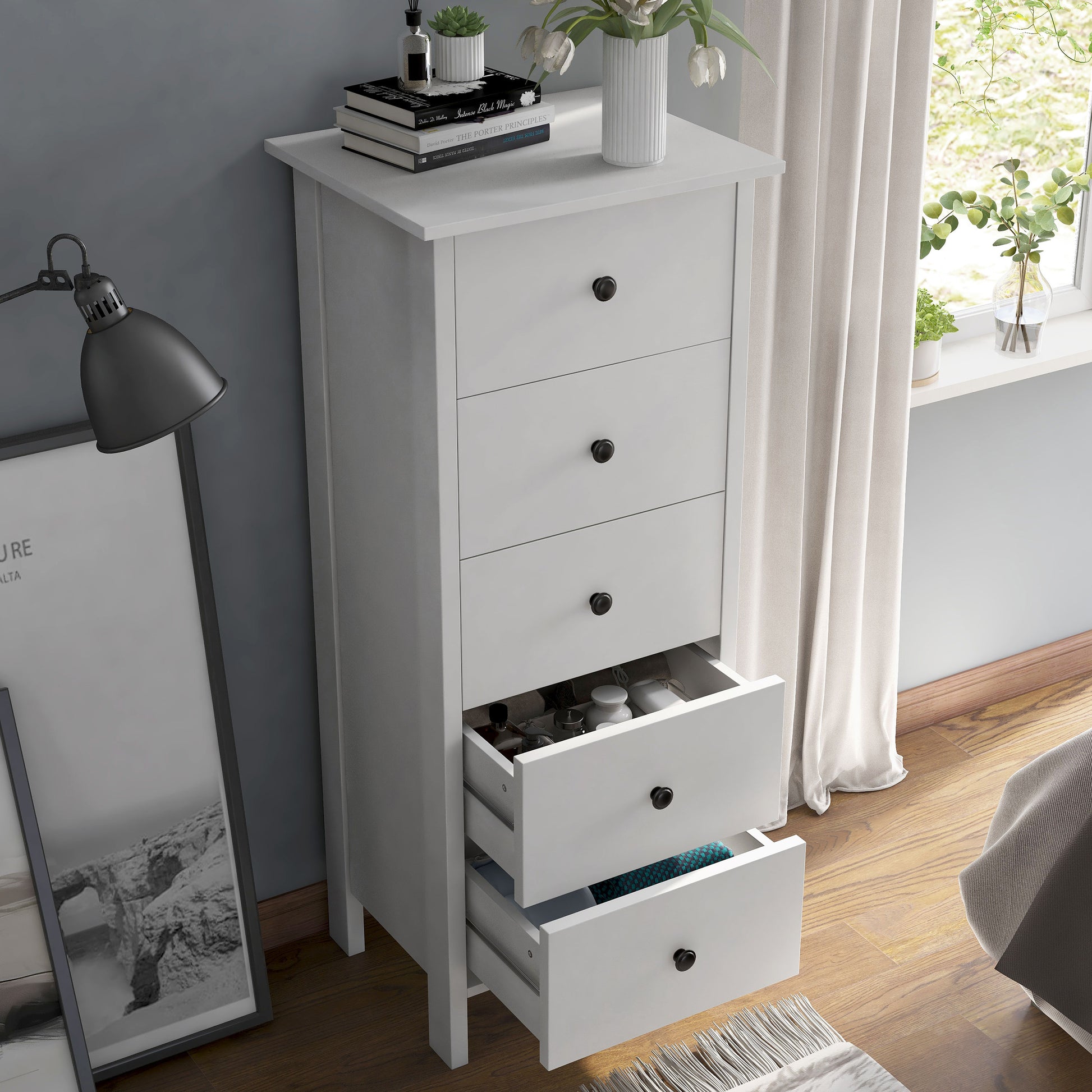 Right angled bird's eye view of a transitional white slim five-drawer chest with two drawers open in a bedroom with accessories
