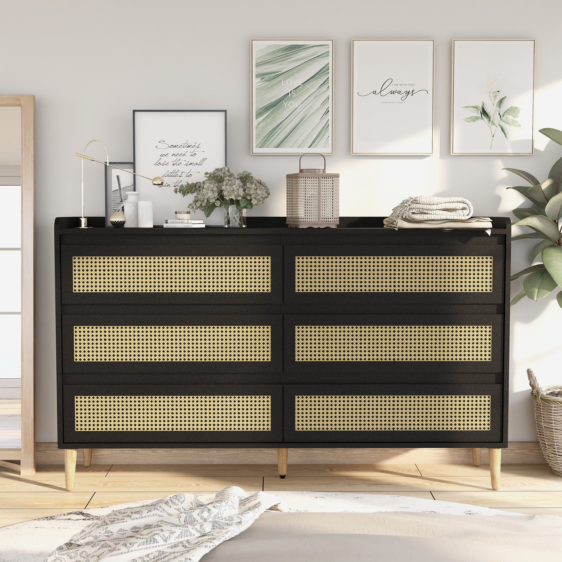 Front-facing mid-century modern black and rattan six-drawer dresser in a bedroom with accessories